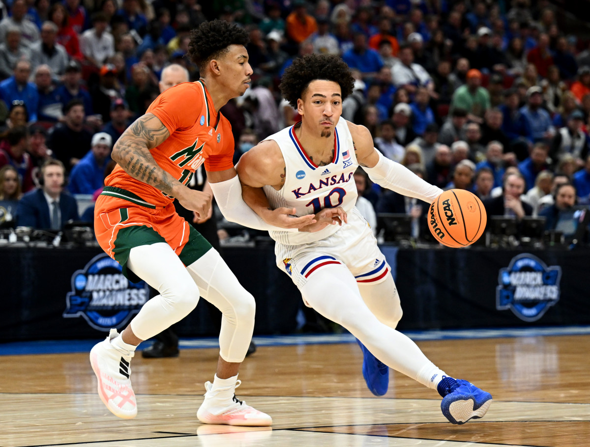 Mar 27, 2022; Chicago, IL, USA; Kansas Jayhawks forward Jalen Wilson (10) drives past Miami Hurricanes guard Jordan Miller (11) during the first half in the finals of the Midwest regional of the men's college basketball NCAA Tournament at United Center. Mandatory Credit: Jamie Sabau-USA TODAY Sports