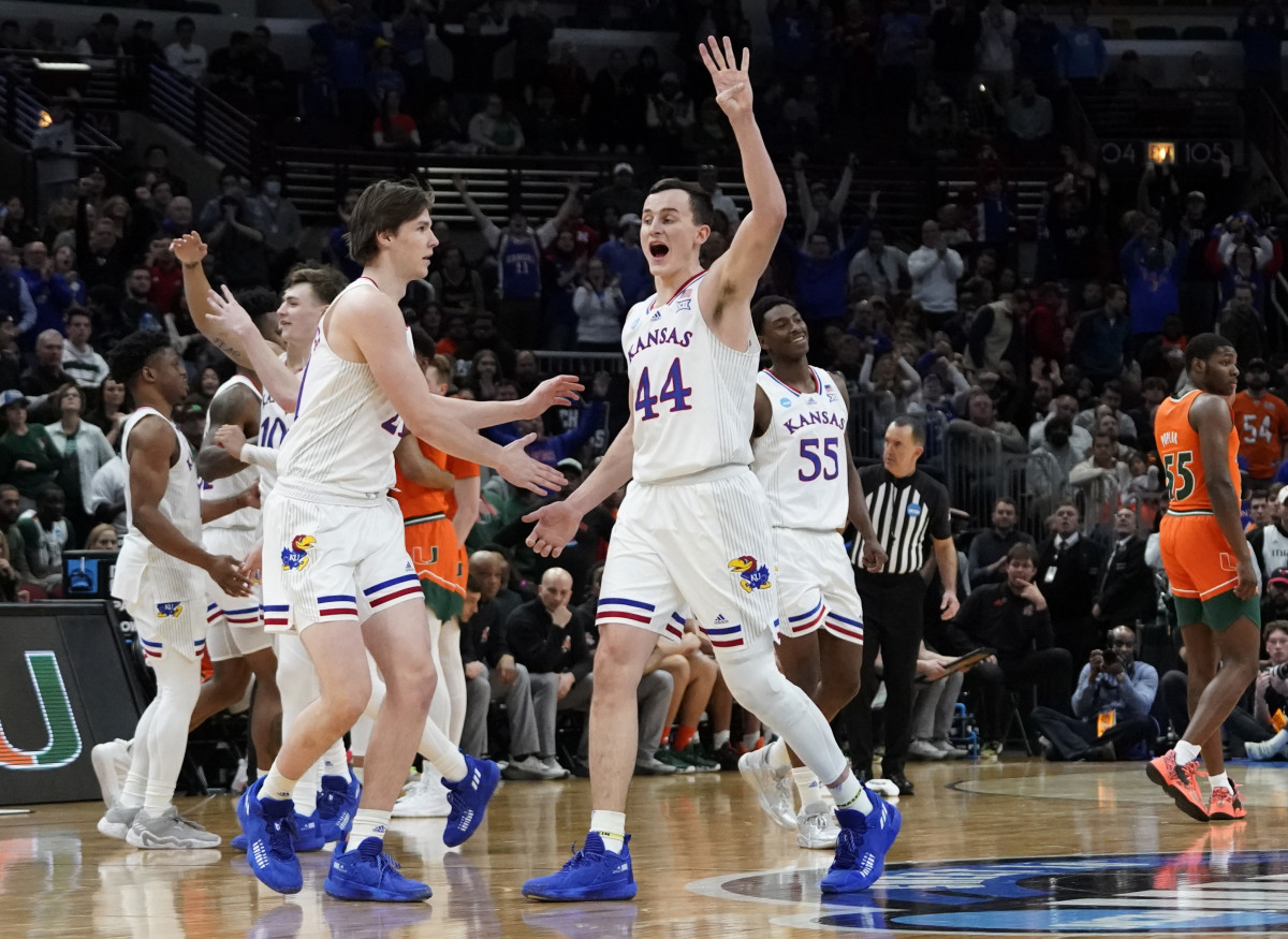 Mar 27, 2022; Chicago, IL, USA; Kansas Jayhawks forward Mitch Lightfoot (44) celebrates with teammates as the Jayhawks defeated the Miami Hurricanes 76-50 in the finals of the Midwest regional of the men's college basketball NCAA Tournament at United Center. Mandatory Credit: David Banks-USA TODAY Sports