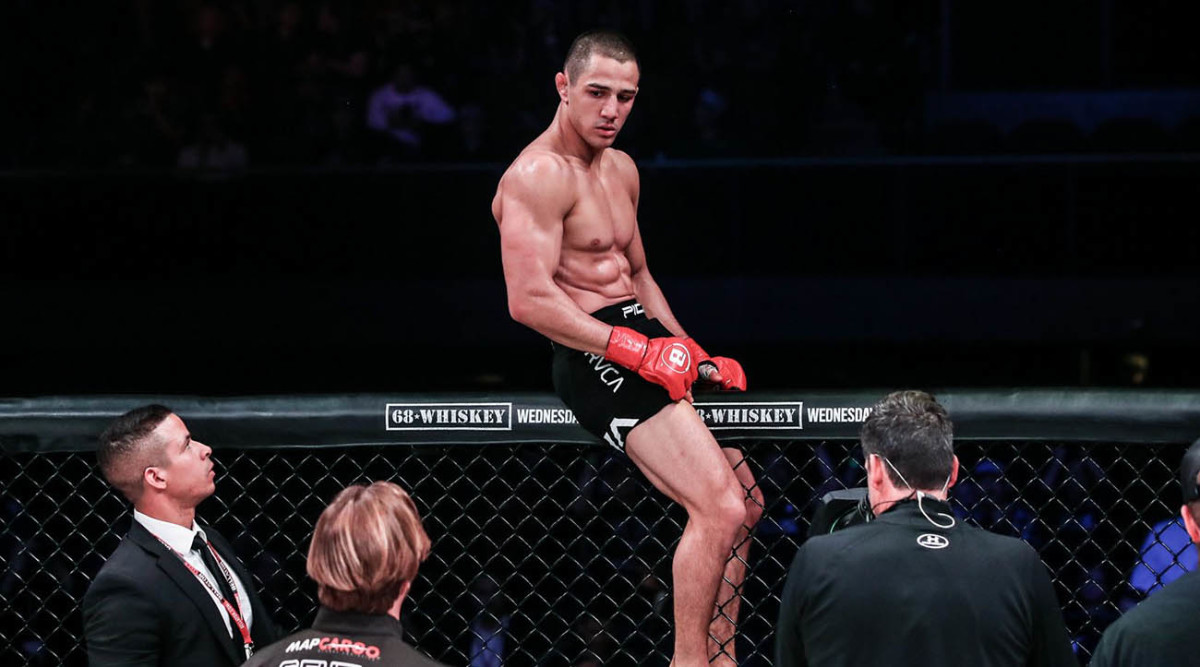 Aaron Pico sits atop the Bellator cage.