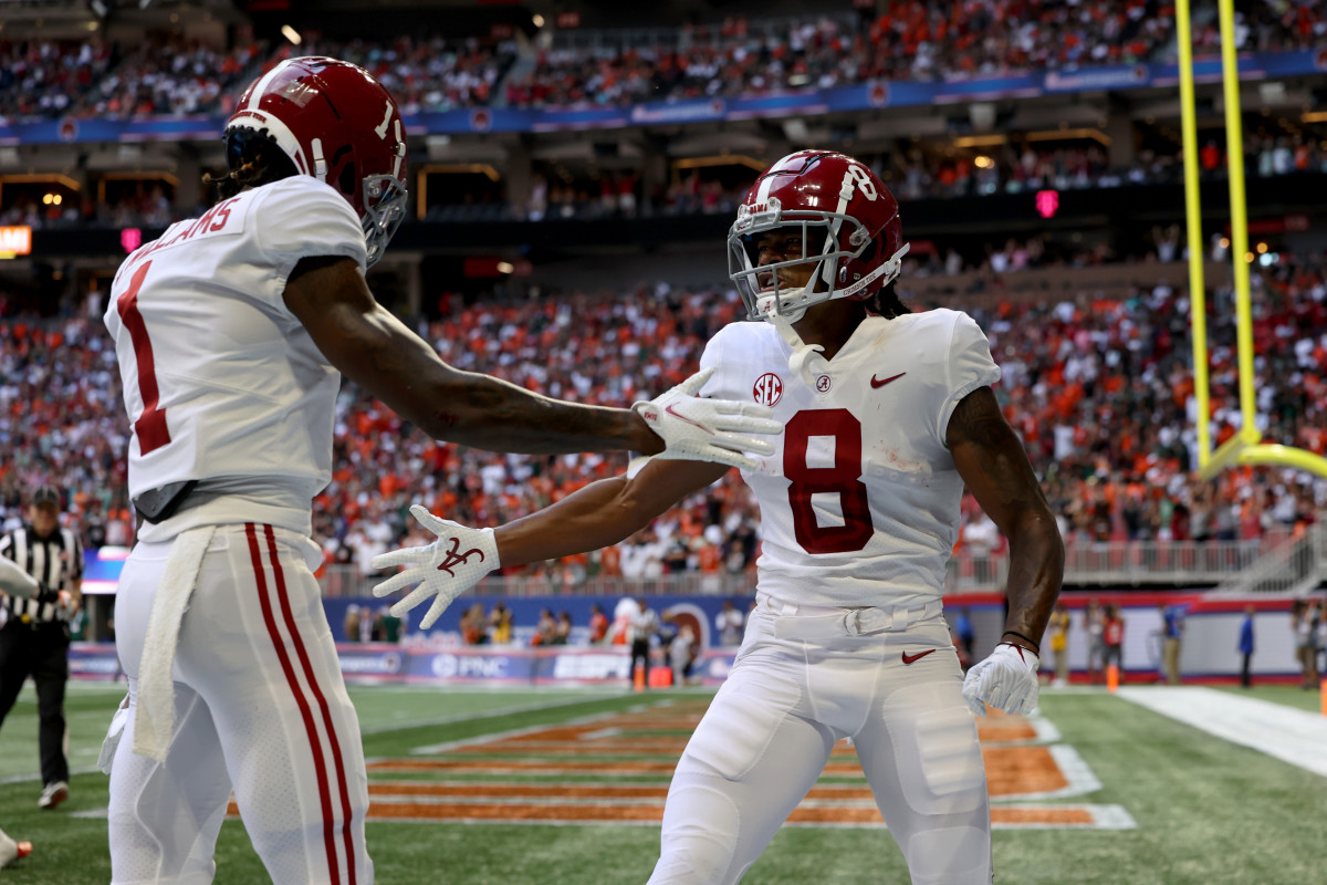 Alabama Crimson Tide wide receiver John Metchie III (8) celebrates his touchdown with wide receiver Jameson Williams (1) during the first quarter against the Miami Hurricanes at Mercedes-Benz Stadium.