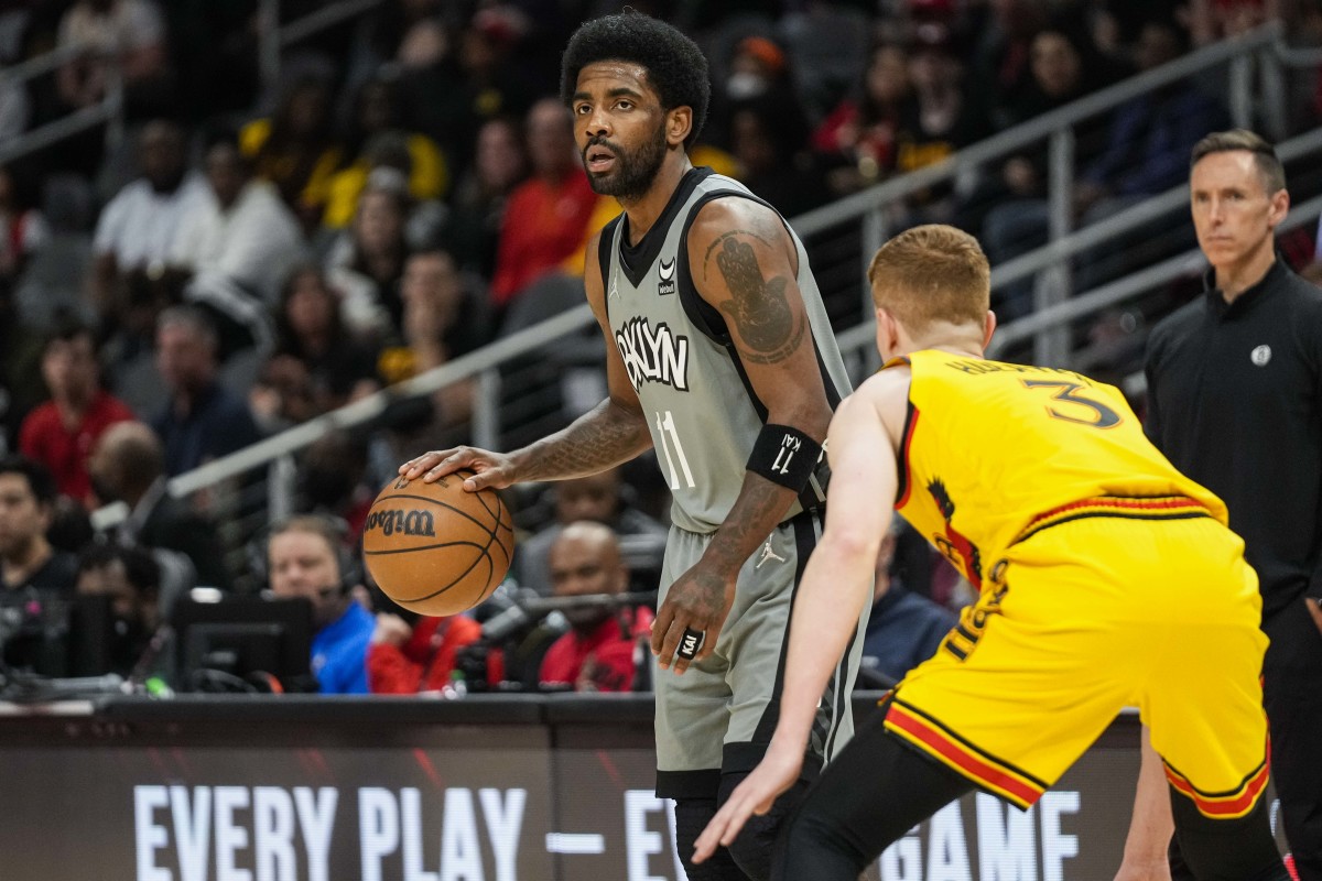 Apr 2, 2022; Atlanta, Georgia, USA; Brooklyn Nets guard Kyrie Irving (11) dribbles guarded by Atlanta Hawks guard Kevin Huerter (3) during the first half at State Farm Arena.