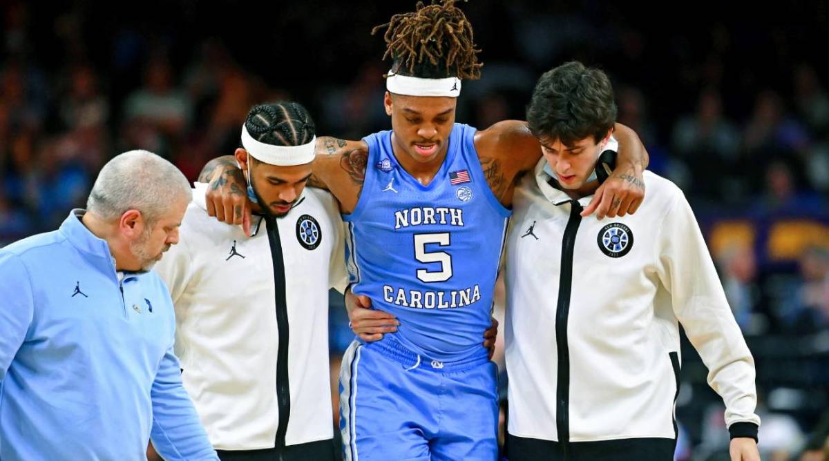 Apr 2, 2022; New Orleans, LA, USA; North Carolina Tar Heels forward Armando Bacot (5) is helped off the court after sustaining an apparent injury after a play against the Duke Blue Devils during the second half during the 2022 NCAA men’s basketball tournament Final Four semifinals at Caesars Superdome.