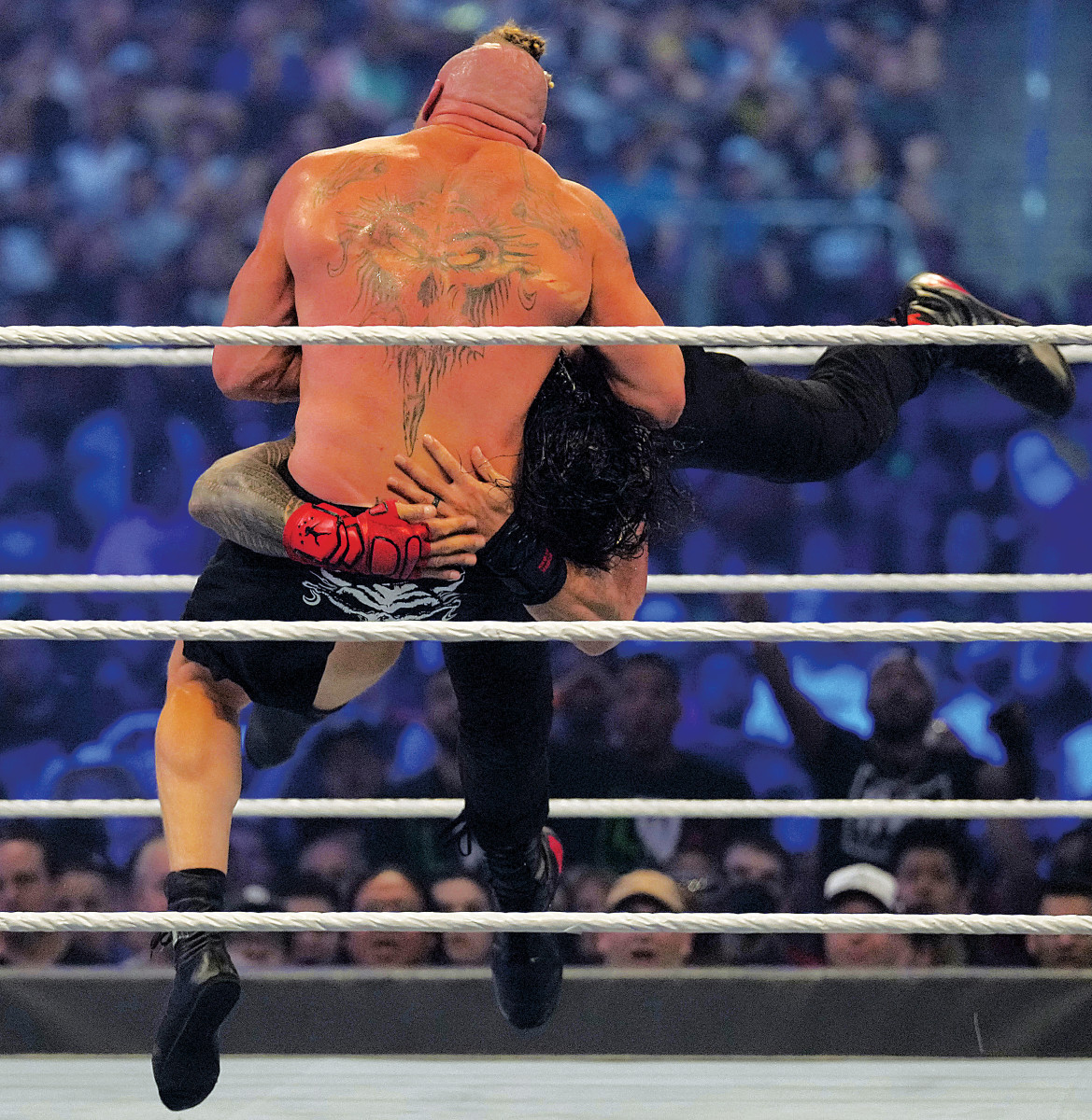 WWE champion Brock Lesnar hits Universal champion Roman Reigns with an F5 during their champion vs. champion match at Wrestlemania 38 in AT&T Stadium in Arlington, Texas.