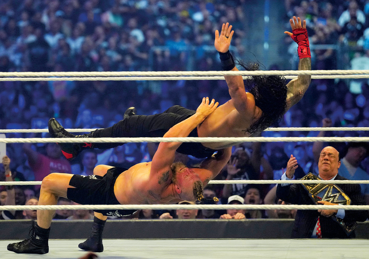 WWE champion Brock Lesnar takes Universal champion Roman Reigns to Suplex City at WrestleMania 38 with one of several belly-to-back suplexes that have become Lesnar's signature moves since introducing it in a squash match against John Cena many years ago.