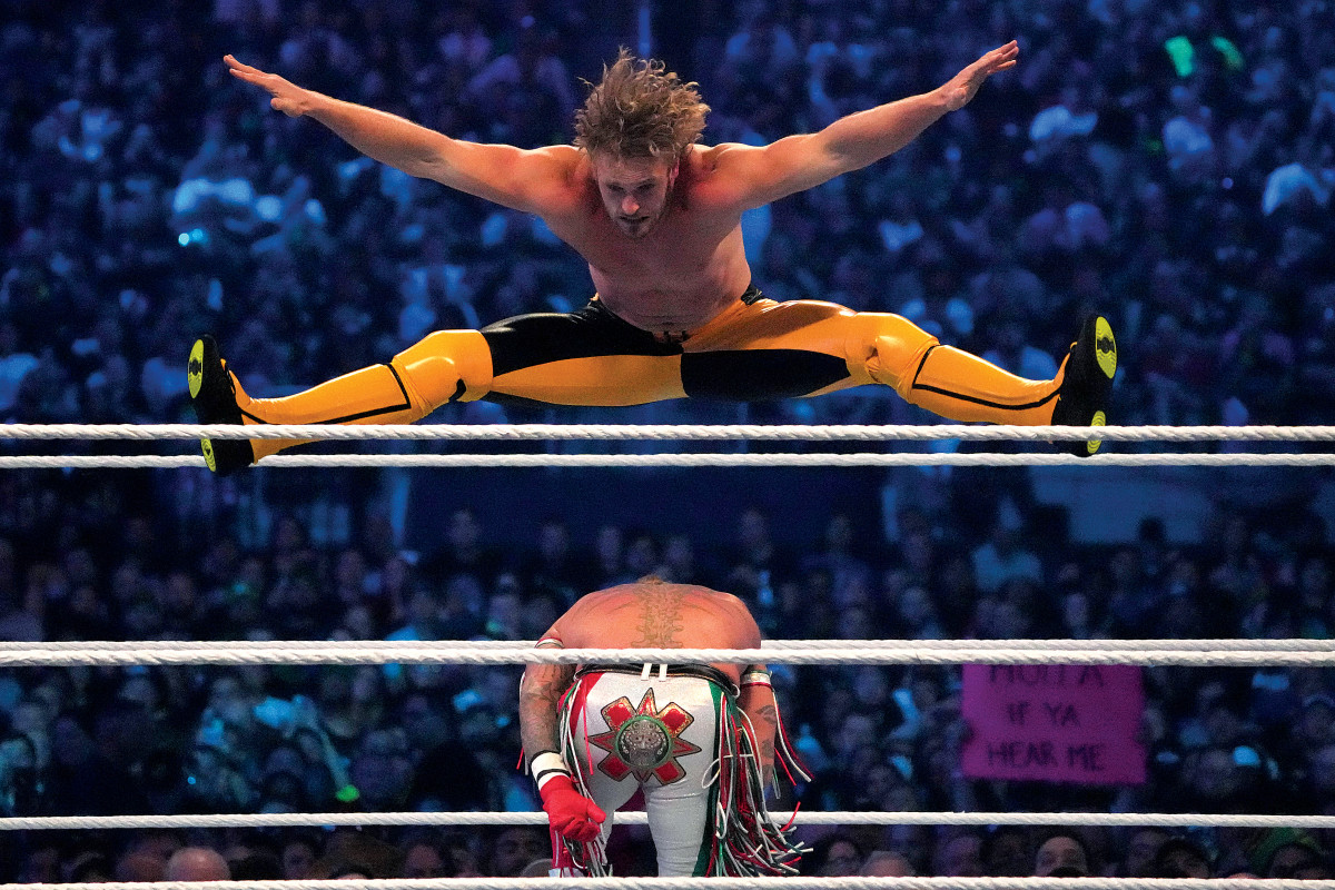 Logan Paul shows off his athletic ability with a high-flying leap from of Rey Mysterio at Wrestlemania 38 at AT&T Stadium in Arlington, Texas.