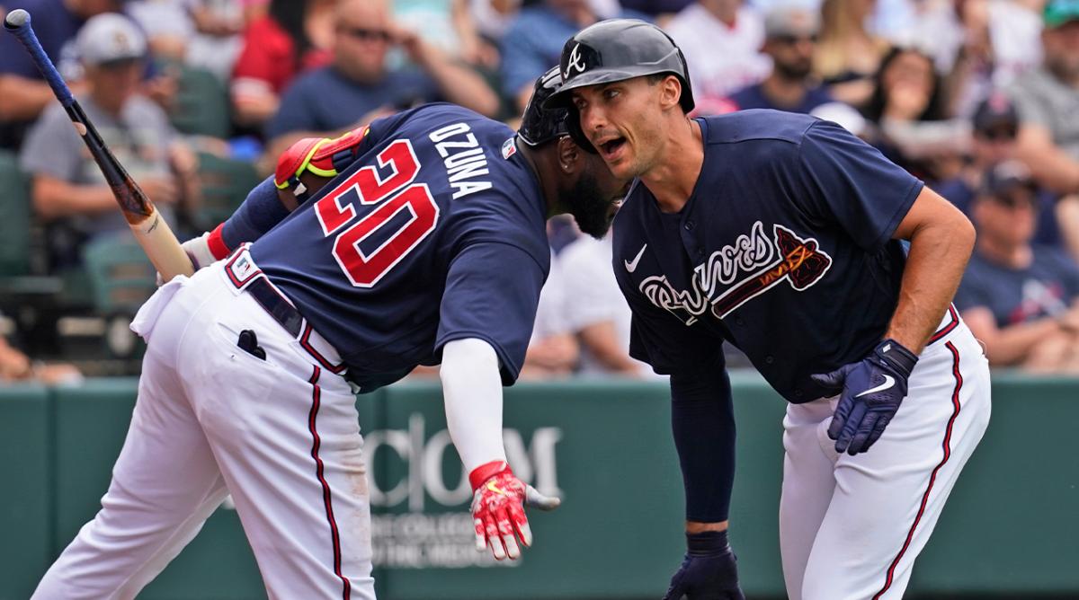 Atlanta Braves first baseman Matt Olson, right, gets a low-five from teammate Marcell Ozuna (20) as he celebrates a first-inning home run during a spring training baseball game against the Boston Red Sox at CoolToday Park, Sunday, April 3, 2022, in North Port, Fla.