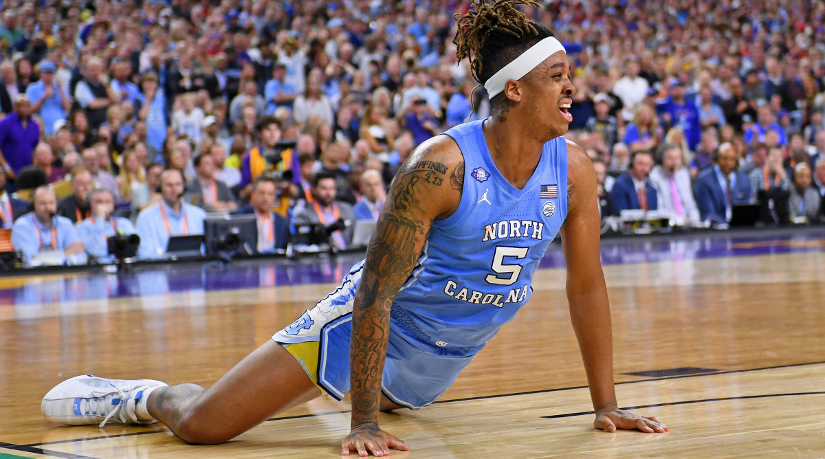 Armando Bacot grimaces in pain after injuring his ankle