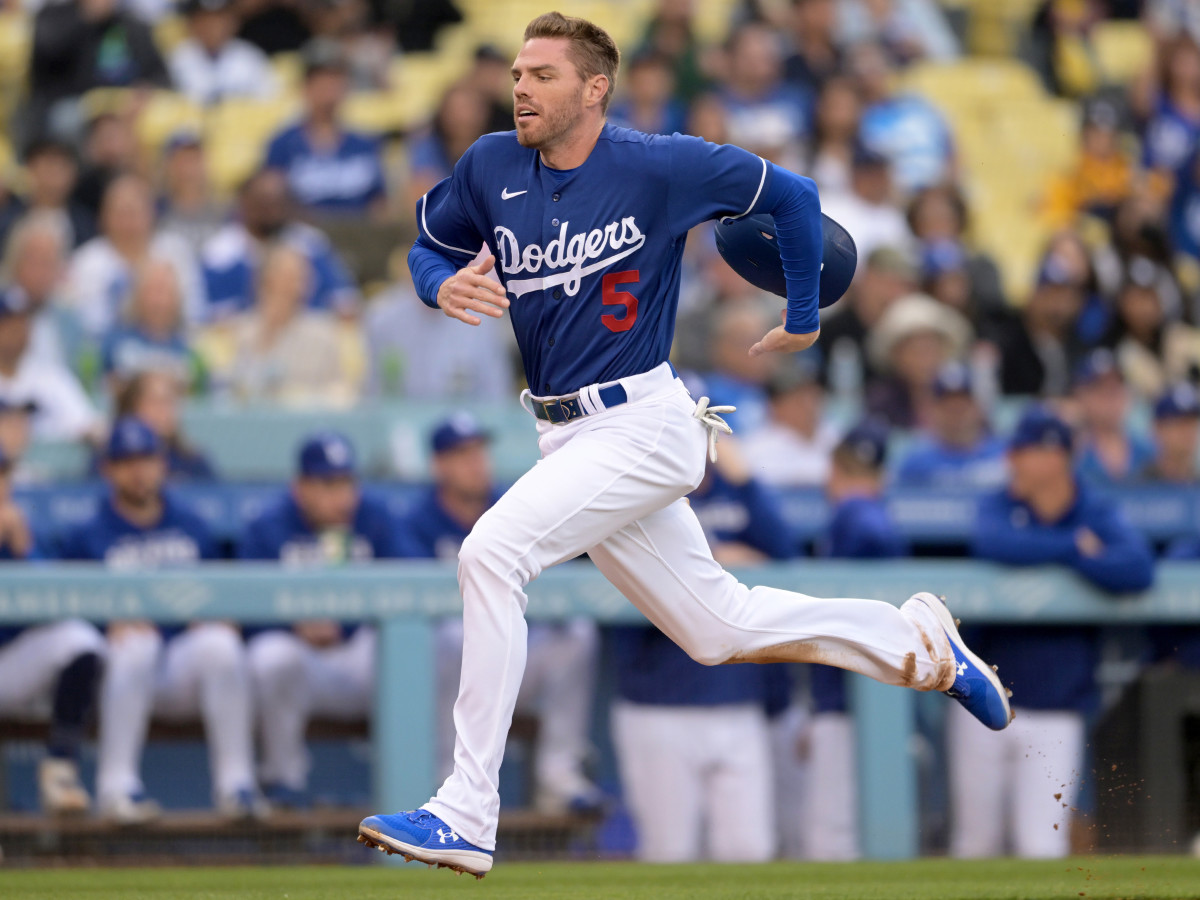 Apr 4, 2022; Los Angeles, California, USA;  Los Angeles Dodgers first baseman Freddie Freeman (5) scores a run from third base in the first inning against the Los Angeles Angels at Dodger Stadium.