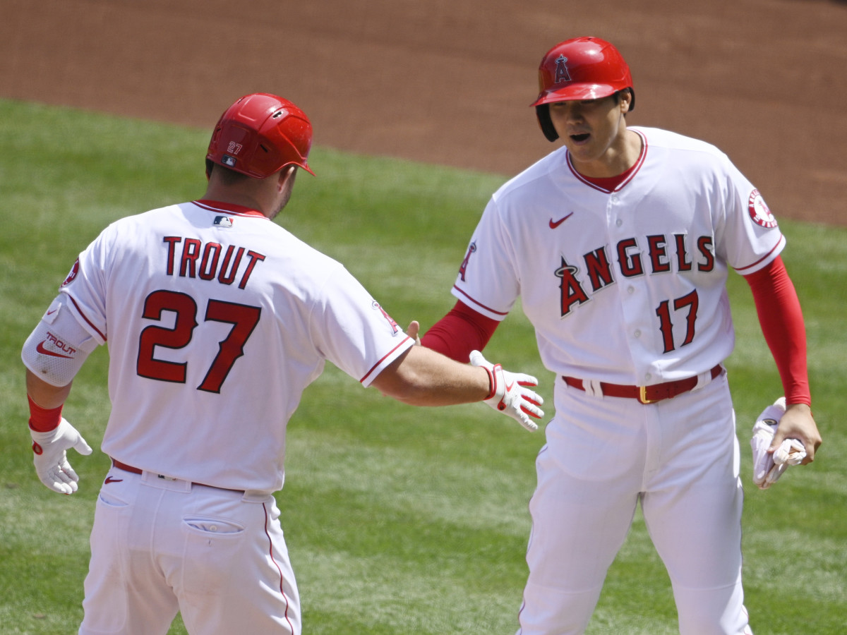 Apr 6, 2021; Anaheim, California, USA; Los Angeles Angels center fielder Mike Trout (27) celebrates his two-run home run with designated hitter Shohei Ohtani (17) during the first inning against the Houston Astros at Angel Stadium.