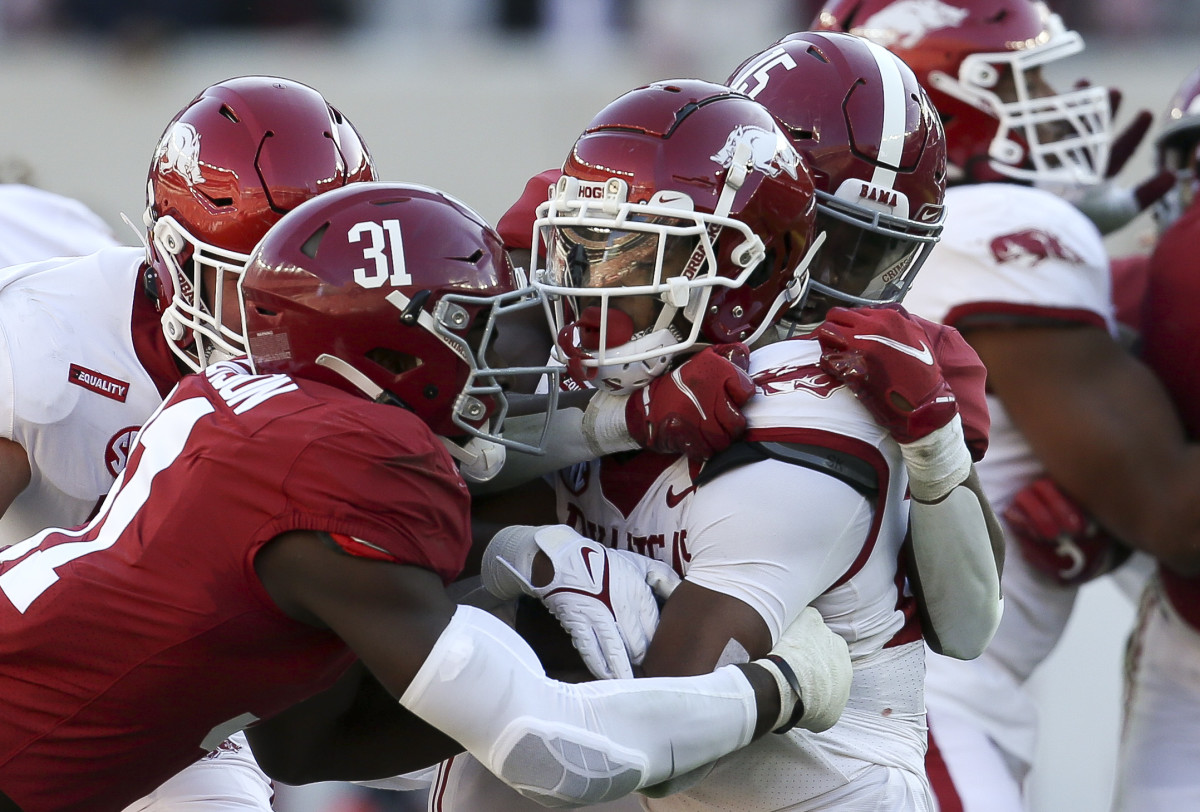 Arkansas running back Trelon Smith (22) is sandwiched by Alabama linebacker Will Anderson Jr. (31) and Alabama linebacker Dallas Turner (15) at Bryant-Denny Stadium.