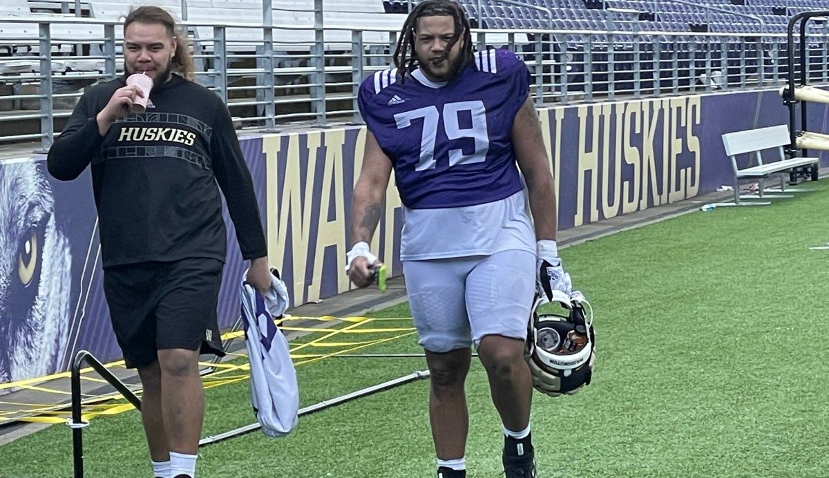 An injured Faatui Tuitele walks with Vic Curne.
