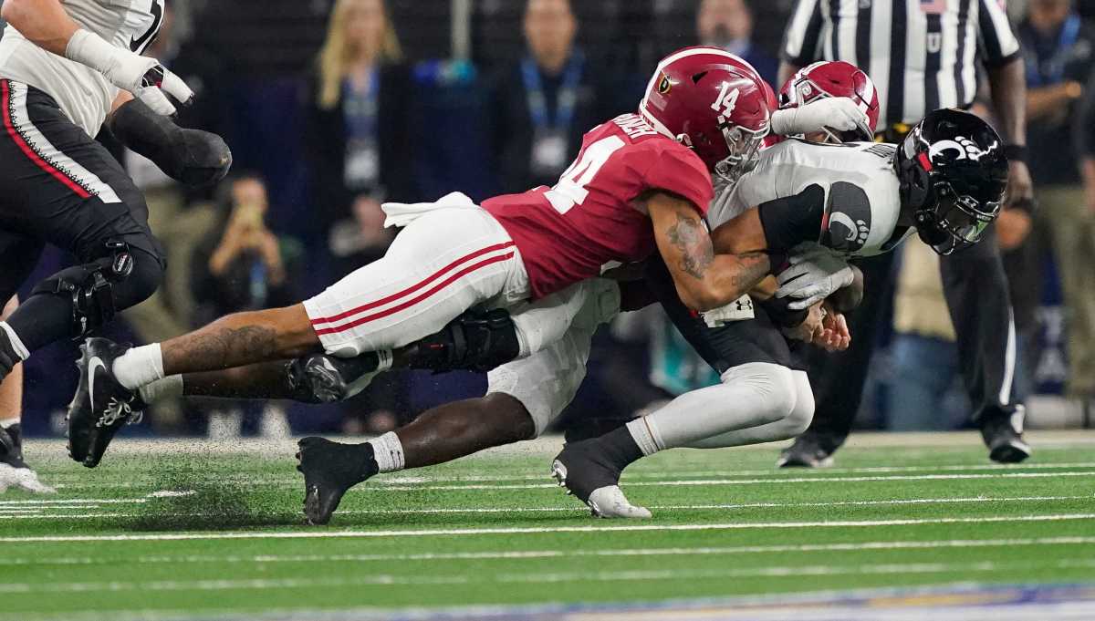 Alabama defensive back Brian Branch (14) and Alabama linebacker Will Anderson Jr. (31) combine to sack Cincinnati quarterback Desmond Ridder (9) during the 2021 College Football Playoff Semifinal game at the 86th Cotton Bowl in AT&T Stadium in Arlington, Texas Friday, Dec. 31, 2021. Alabama defeated Cincinnati 27-6 to advance to the national championship game.