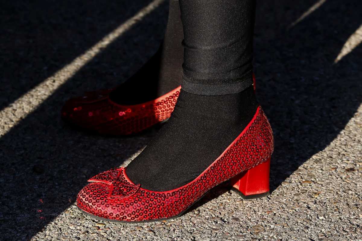 Katlin Hasen wears ruby red slippers to compliment her costume as Dorothy from \"The Wizard of Oz\" during Reeb Avenue Center's Trunk-or-Treat in Columbus, Ohio Oct. 26. Hasen and her family were different characters from the film. Wildart South Side Halloween Njg 001