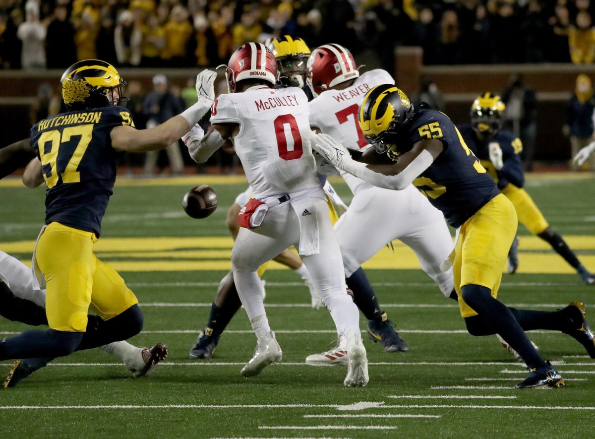 Michigan Wolverines defensive end Aidan Hutchinson (97) and linebacker David Ojabo (55) force a fumble by Indiana Hoosiers quarterback Donaven McCulley (0) during first half action Saturday, Nov. 6, 2021 at Michigan Stadium. Mich Ind Syndication Detroit Free Press