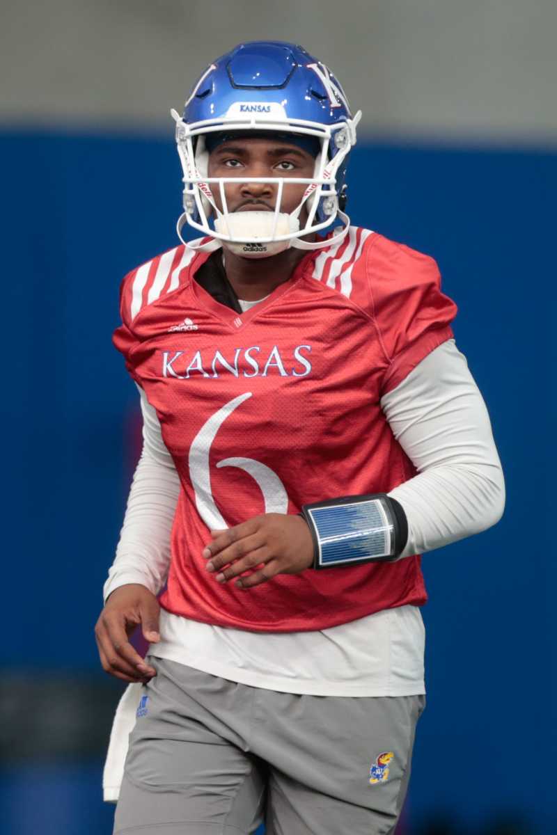 Kansas junior quarterback Jalon Daniels (6) runs to the next position during practice Tuesday morning in Lawrence.