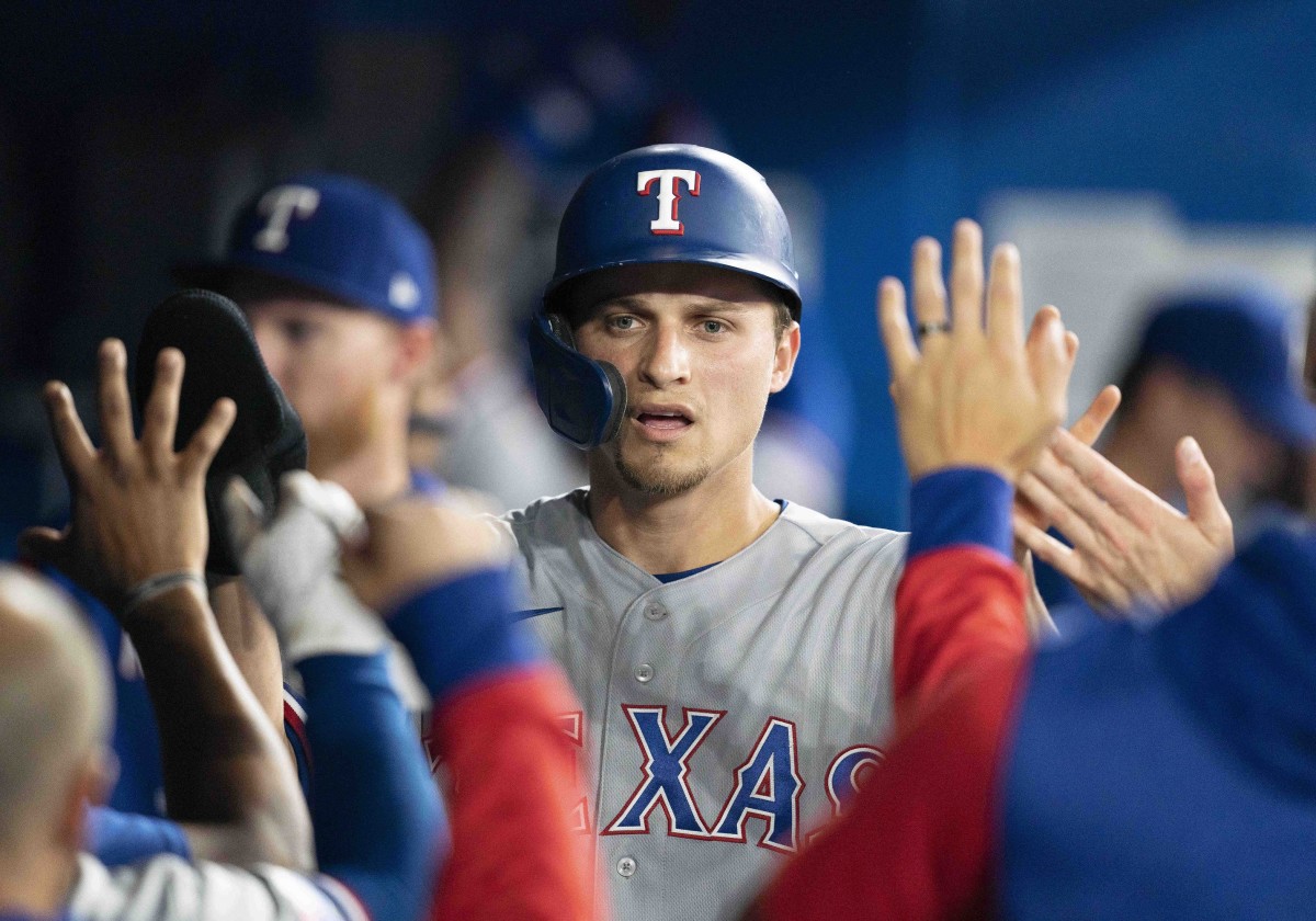 Apr 8, 2022; Toronto, Ontario, CAN; Texas Rangers shortstop Corey Seager (5) celebrates in the dugout after scoring a run during the fourth inning against the Toronto Blue Jays at Rogers Centre . Mandatory Credit: Nick Turchiaro-USA TODAY Sports