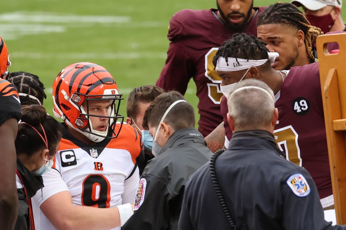 Nov 22, 2020; Landover, Maryland, USA; Cincinnati Bengals quarterback Joe Burrow (9) shakes hands with Washington Football Team quarterback Dwayne Haskins Jr. (7) prior to being carted off the field after injuring his left knee in the third quarter at FedExField. Mandatory Credit: Geoff Burke-USA TODAY Sports