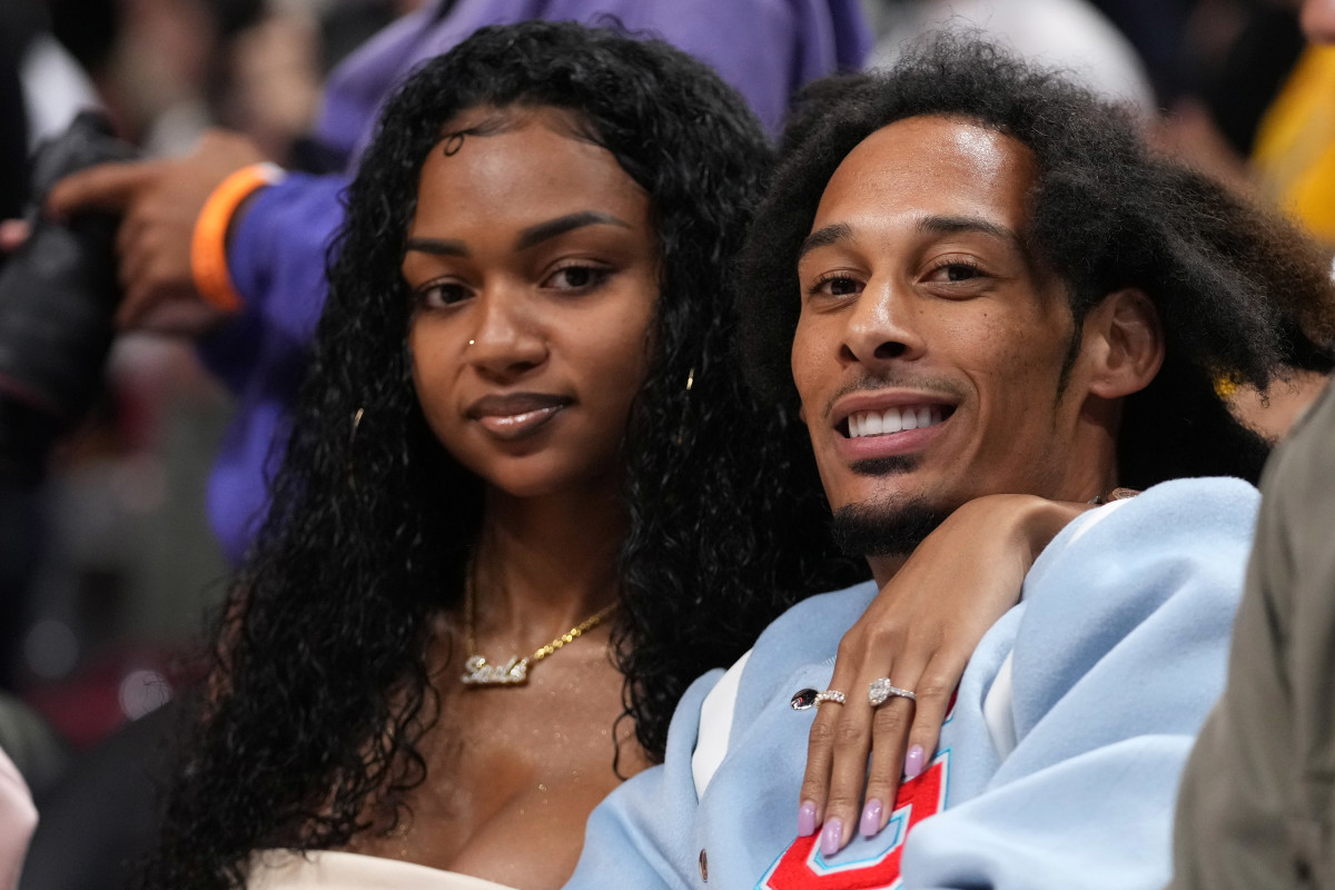 Apr 8, 2022; Miami, Florida, USA; Carolina Panthers wide receiver Robbie Anderson (R) sits court-side with his fiancee Sade Vanessa (L) during the second half of the game between the Miami Heat and the Atlanta Hawks at FTX Arena.