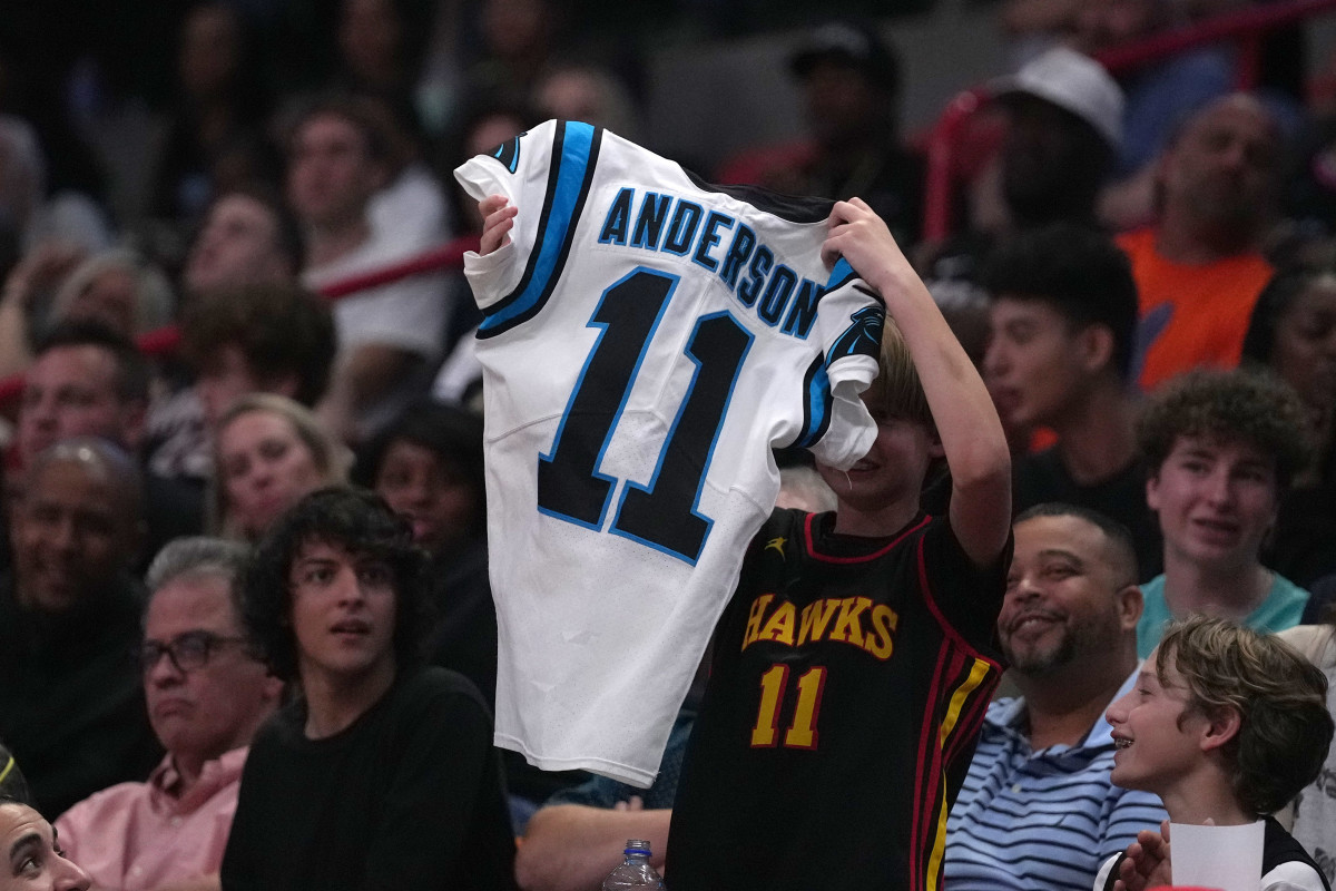 Apr 8, 2022; Miami, Florida, USA; A young fan catches a jersey from Carolina Panthers wide receiver Robbie Anderson who was in attendance during the second half of the game between the Miami Heat and the Atlanta Hawks at FTX Arena.