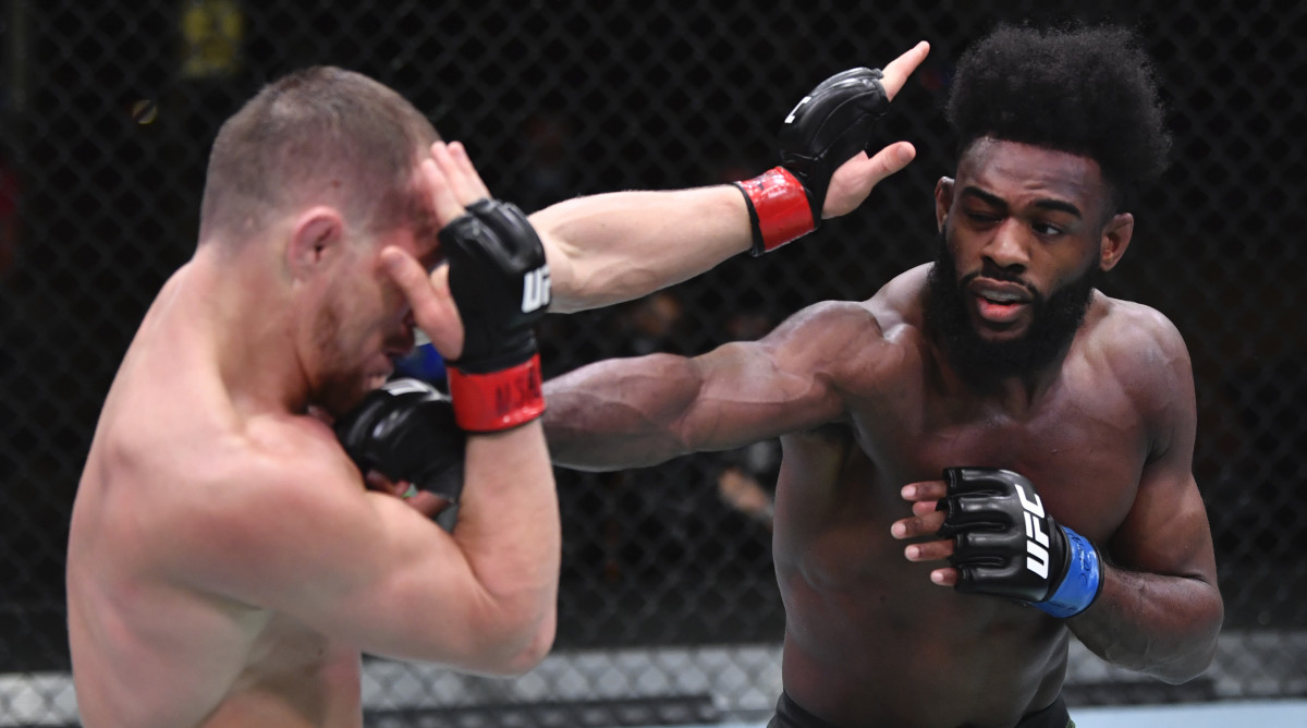 Aljamain Sterling punches Petr Yan of Russia in their UFC bantamweight championship fight during the UFC 259 event at UFC APEX on March 06, 2021 in Las Vegas, Nevada.