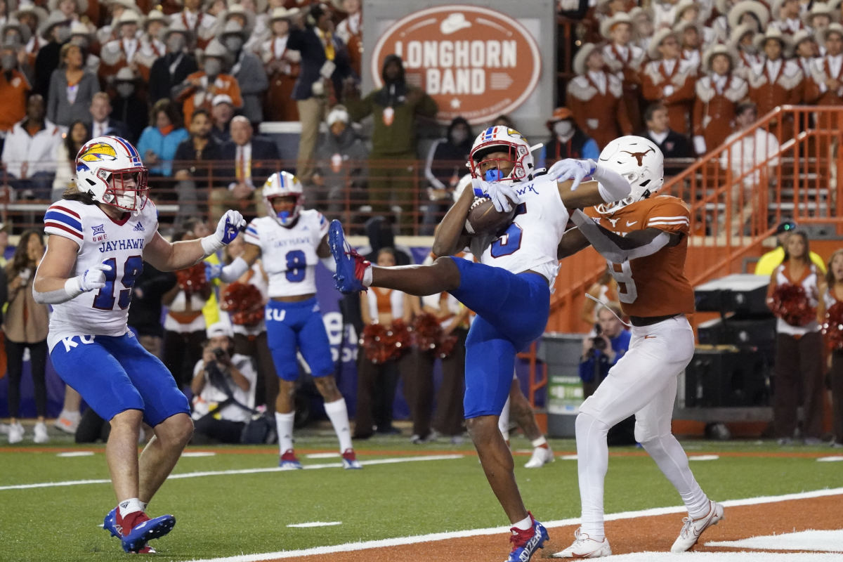 Nov 13, 2021; Austin, Texas, USA; Kansas Jayhawks safety OJ Burroughs (5) intercepts a pass in the end zone intended for Texas Longhorns wide receiver Xavier Worthy (8) in the second half at Darrell K Royal-Texas Memorial Stadium. Mandatory Credit: Scott Wachter-USA TODAY Sports