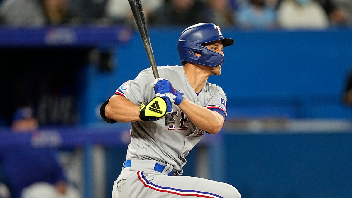 Apr 10, 2022; Toronto, Ontario, CAN; Texas Rangers shortstop Corey Seager (5) hits a single during the eighth inning against the Texas Rangers at Rogers Centre. Mandatory Credit: John E. Sokolowski-USA TODAY Sports