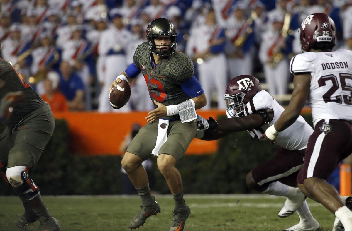 Oct 14, 2017; Gainesville, FL, USA;Florida Gators quarterback Feleipe Franks (13) runs out of the pocket as Texas A&M Aggies defensive end Michael Clemons (48) pressures during the first half at Ben Hill Griffin Stadium. Mandatory Credit: Kim Klement-USA TODAY Sports