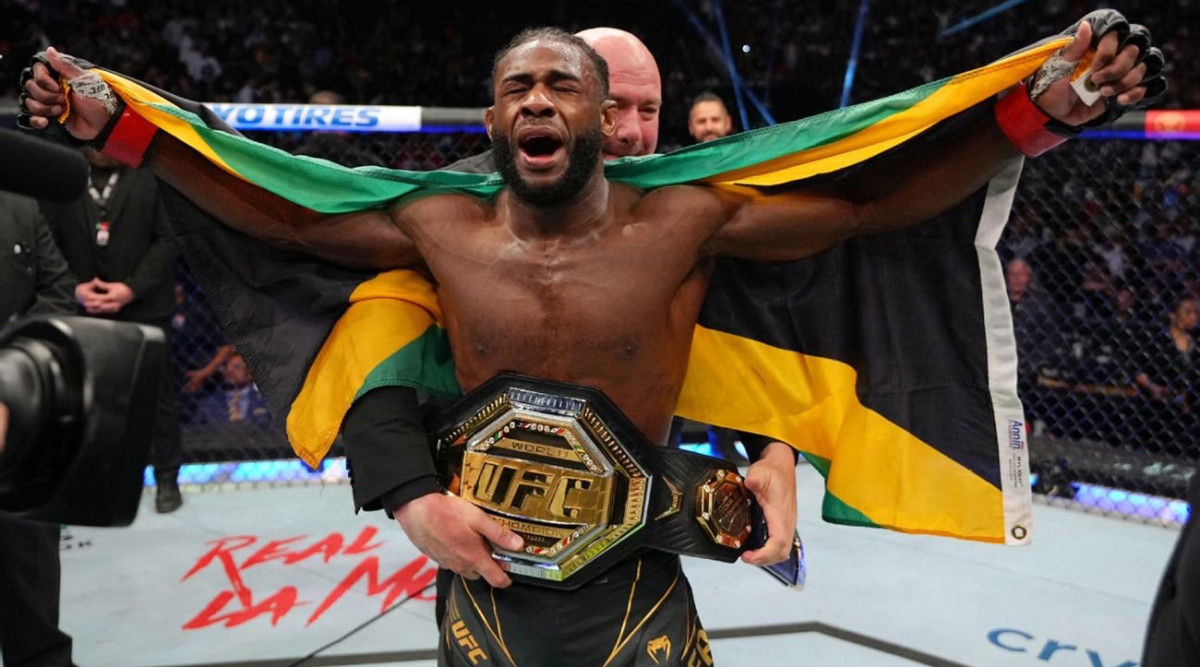 Aljamain Sterling celebrates after defeating Petr Yan in their bantamweight unification title fight at UFC 273.