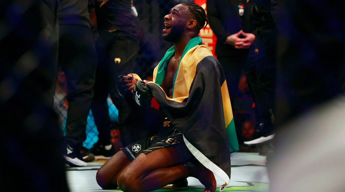 Aljamain Sterling reacts to winning the bantamweight title belt by split decision against Petr Yan, not shown, during UFC 273.