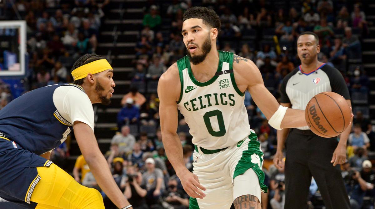 Boston Celtics forward Jayson Tatum (0) handles the ball against Memphis Grizzlies guard Ziaire Williams in the second half of an NBA basketball game Sunday, April 10, 2022, in Memphis, Tenn.