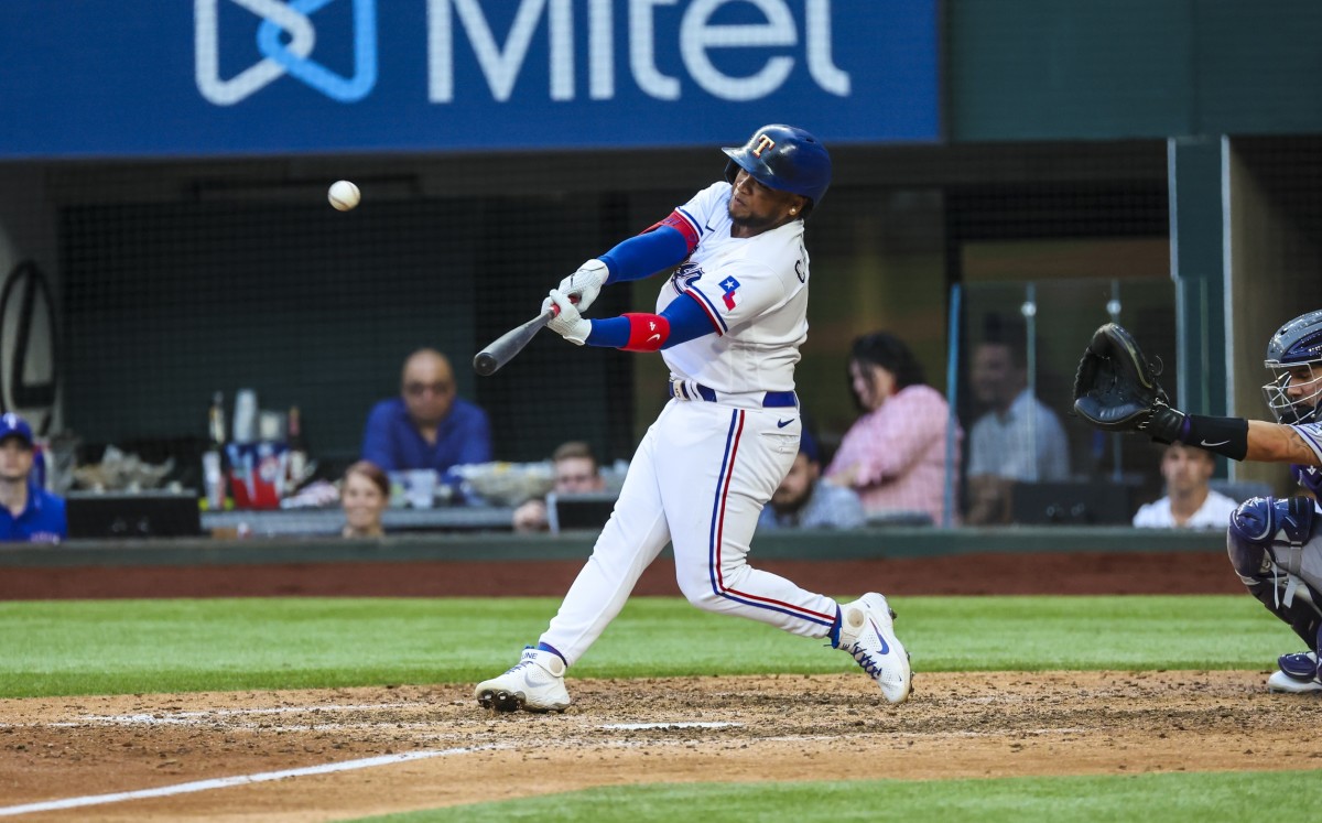 Apr 11, 2022; Arlington, Texas, USA; Texas Rangers left fielder Willie Calhoun (4) hits a home run during the ninth inning against the Colorado Rockies at Globe Life Field. Mandatory Credit: Kevin Jairaj-USA TODAY Sports