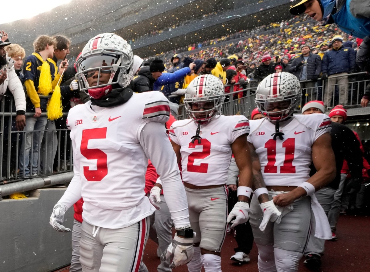 Ohio State Buckeyes wide receivers Garrett Wilson (5), Chris Olave (2) and Jaxon Smith-Njigba (11) take the the field for the NCAA football game against the Michigan Wolverines at Michigan Stadium in Ann Arbor on Sunday, Nov. 28, 2021. Ohio State Buckeyes At Michigan Wolverines