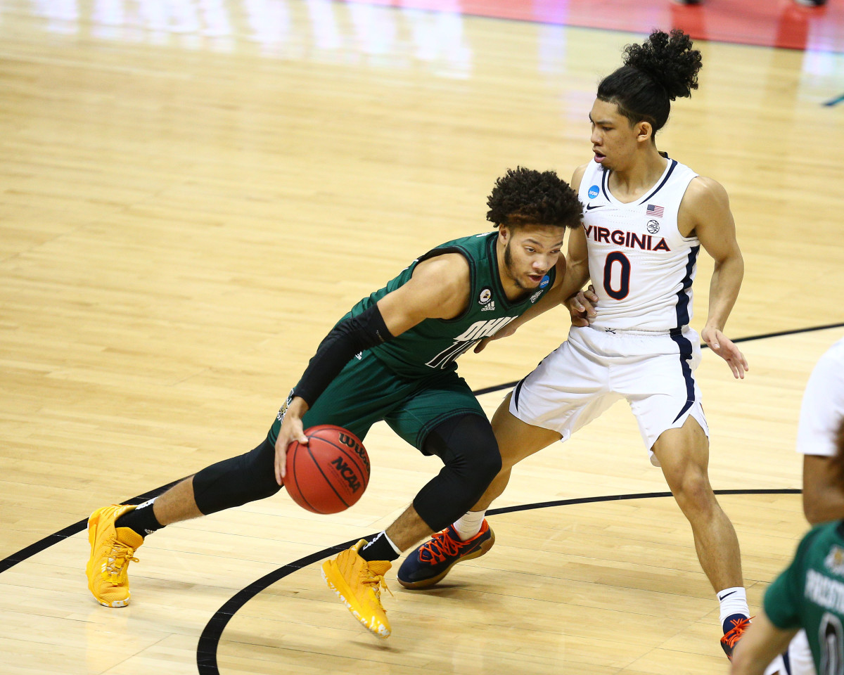 Ohio Bobcats guard Mark Sears (10) moves the ball against Virginia Cavaliers guard Kihei Clark (0) during the second half in the first round of the 2021 NCAA Tournament at Simon Skjodt Assembly Hall.