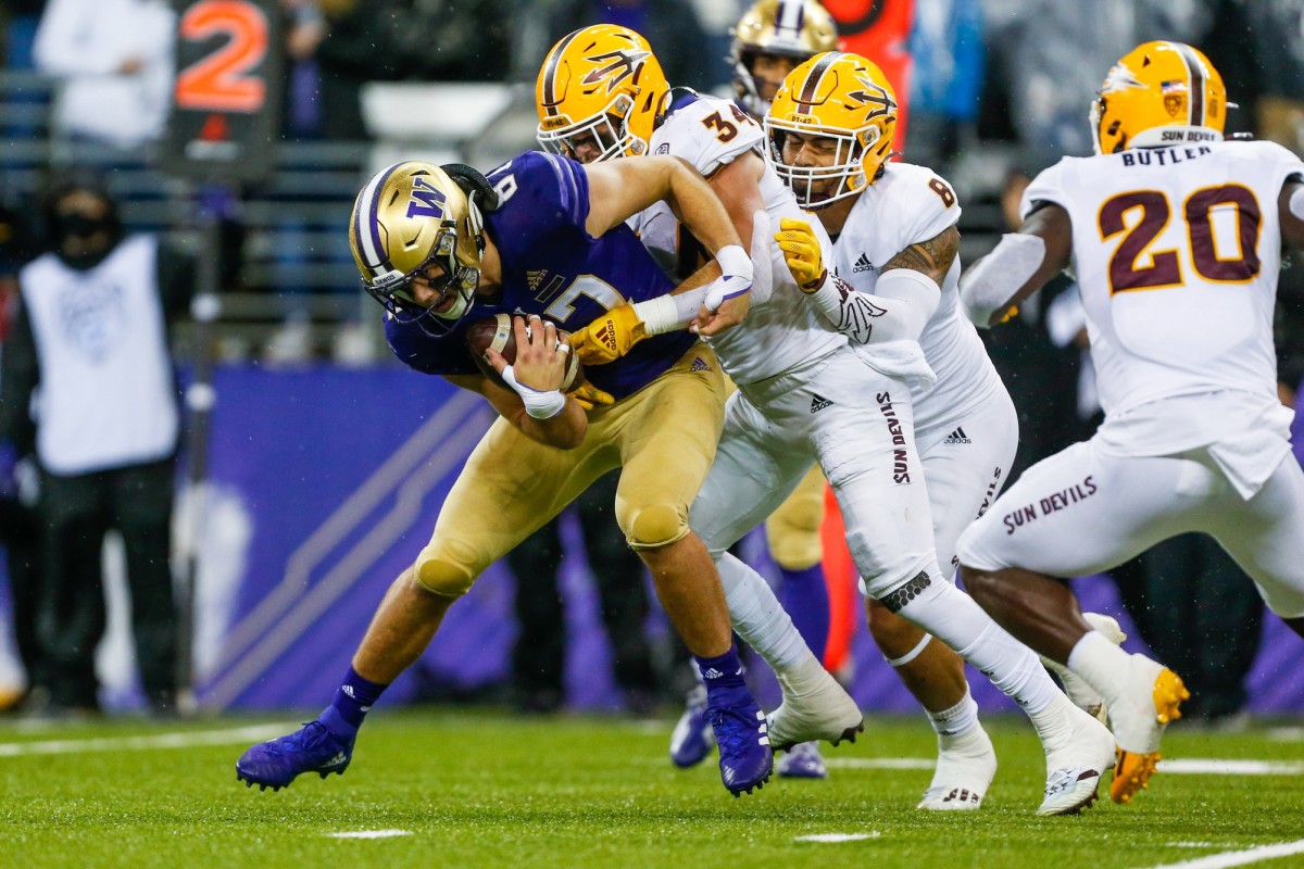 Nov 13, 2021; Seattle, Washington, USA; Washington Huskies tight end Cade Otton (87) is tackled by Arizona State Sun Devils linebacker Kyle Soelle (34) and linebacker Merlin Robertson (8) after catching a pass during the second quarter at Alaska Airlines Field at Husky Stadium.