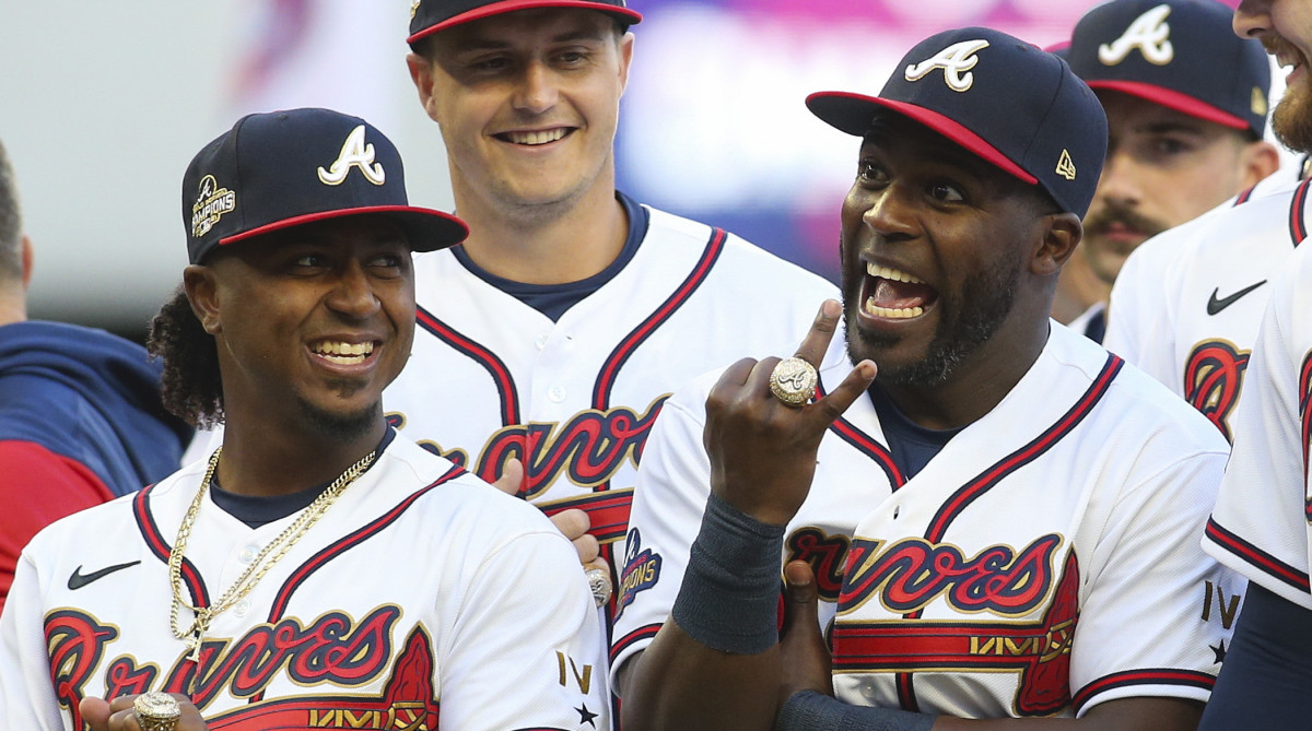 Atlanta Braves second baseman Ozzie Albies (1) and center fielder Guillermo Heredia (38) celebrate after receiving World Series championship rings