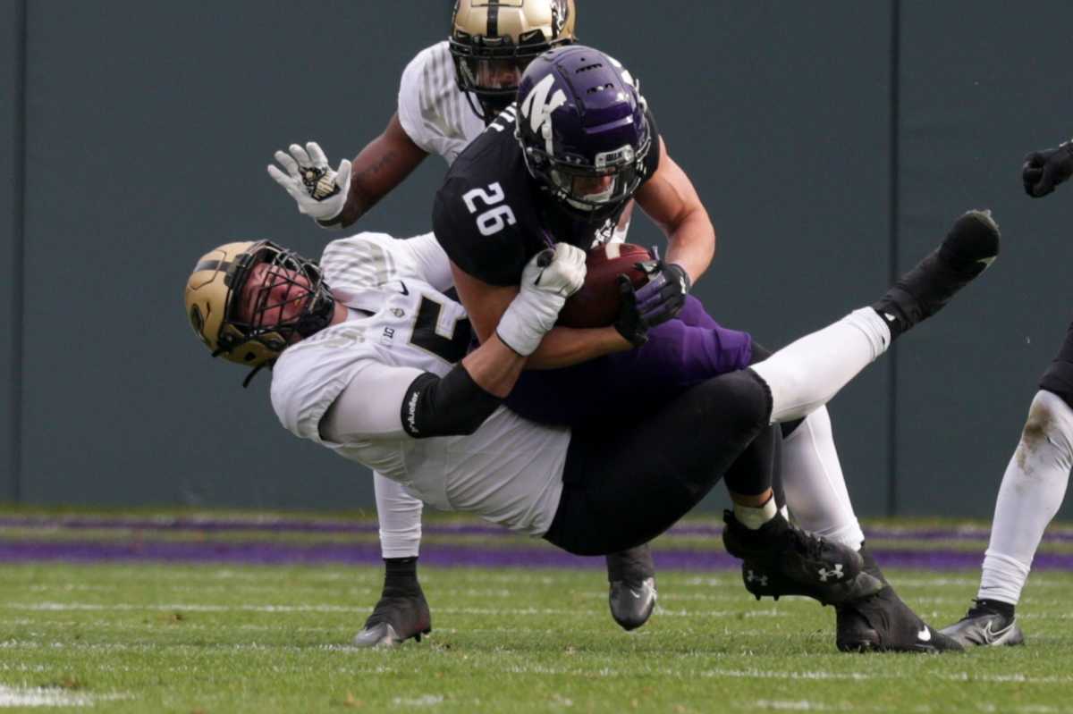 Purdue defensive end George Karlaftis (5) tackles Northwestern running back Evan Hull (26) during the first quarter of an NCAA college football game, Saturday, Nov. 20, 2021 at Wrigley Field in Chicago. Cfb Purdue Vs Northwestern