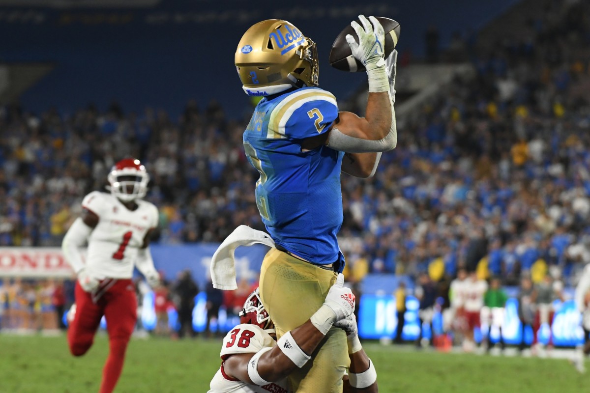 Sep 18, 2021; Pasadena, California, USA; UCLA Bruins wide receiver Kyle Philips (2) makes a catch for a touchdown against Fresno State Bulldogs defensive back Bralyn Lux (38) in the fourth quarter at Rose Bowl. Mandatory Credit: Richard Mackson-USA TODAY Sports