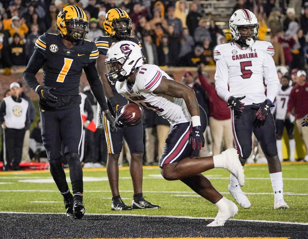 Nov 13, 2021; Columbia, Missouri, USA; South Carolina Gamecocks running back ZaQuandre White (11) scores a touchdown as Missouri Tigers defensive back Jaylon Carlies (1) looks on during the second half at Faurot Field at Memorial Stadium.