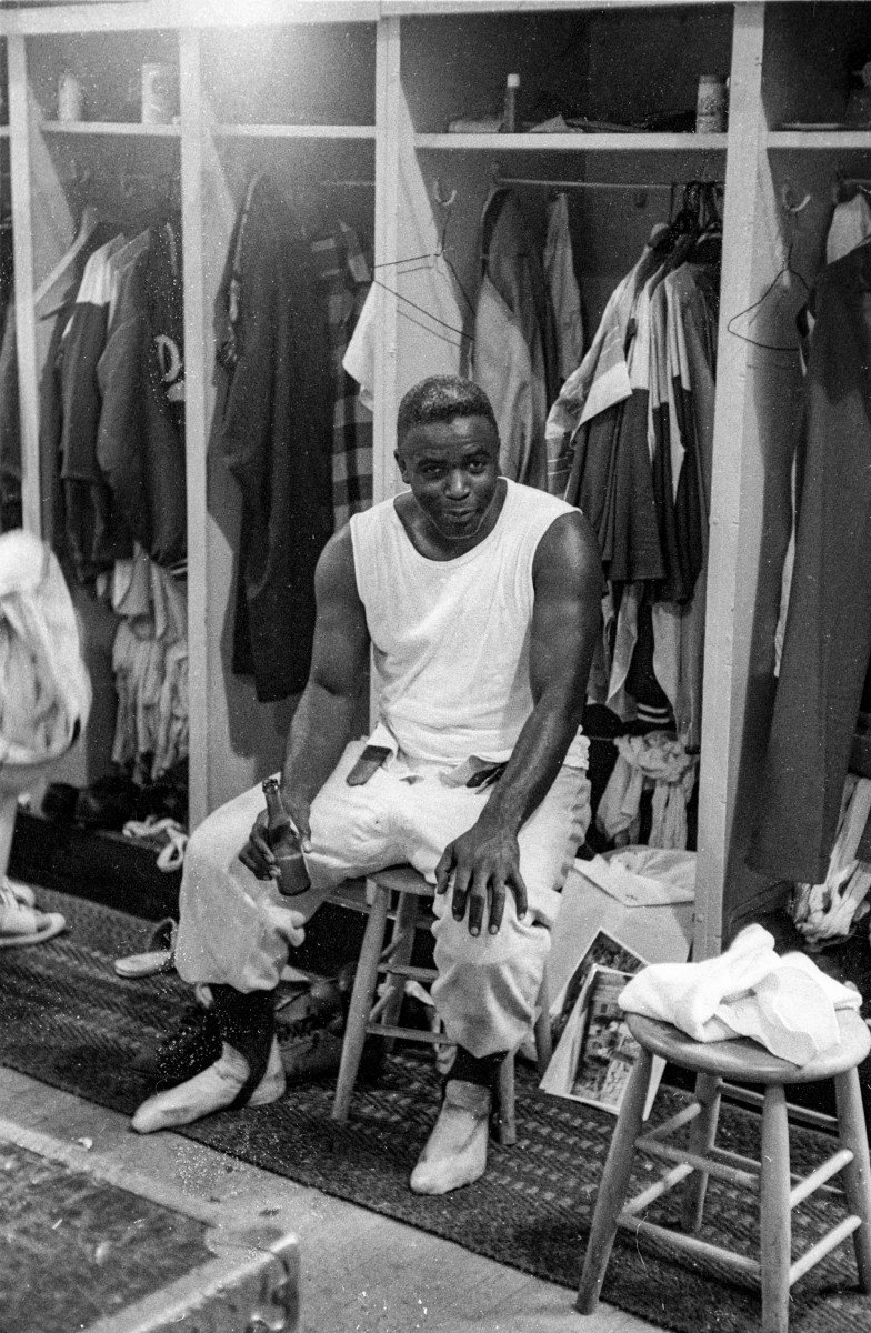 Jackie Robinson sitting at his lockout drinking a postgame beer.