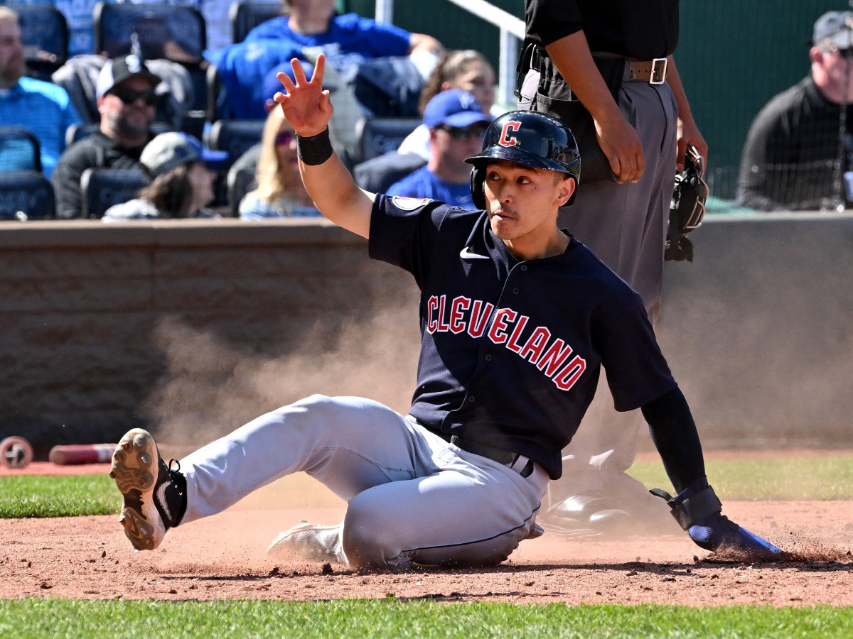 Apr 11, 2022; Kansas City, Missouri, USA;  Cleveland Guardians left fielder Steven Kwan (38) slides home, scoring a run during the seventh inning against the Kansas City Royals at Kauffman Stadium.