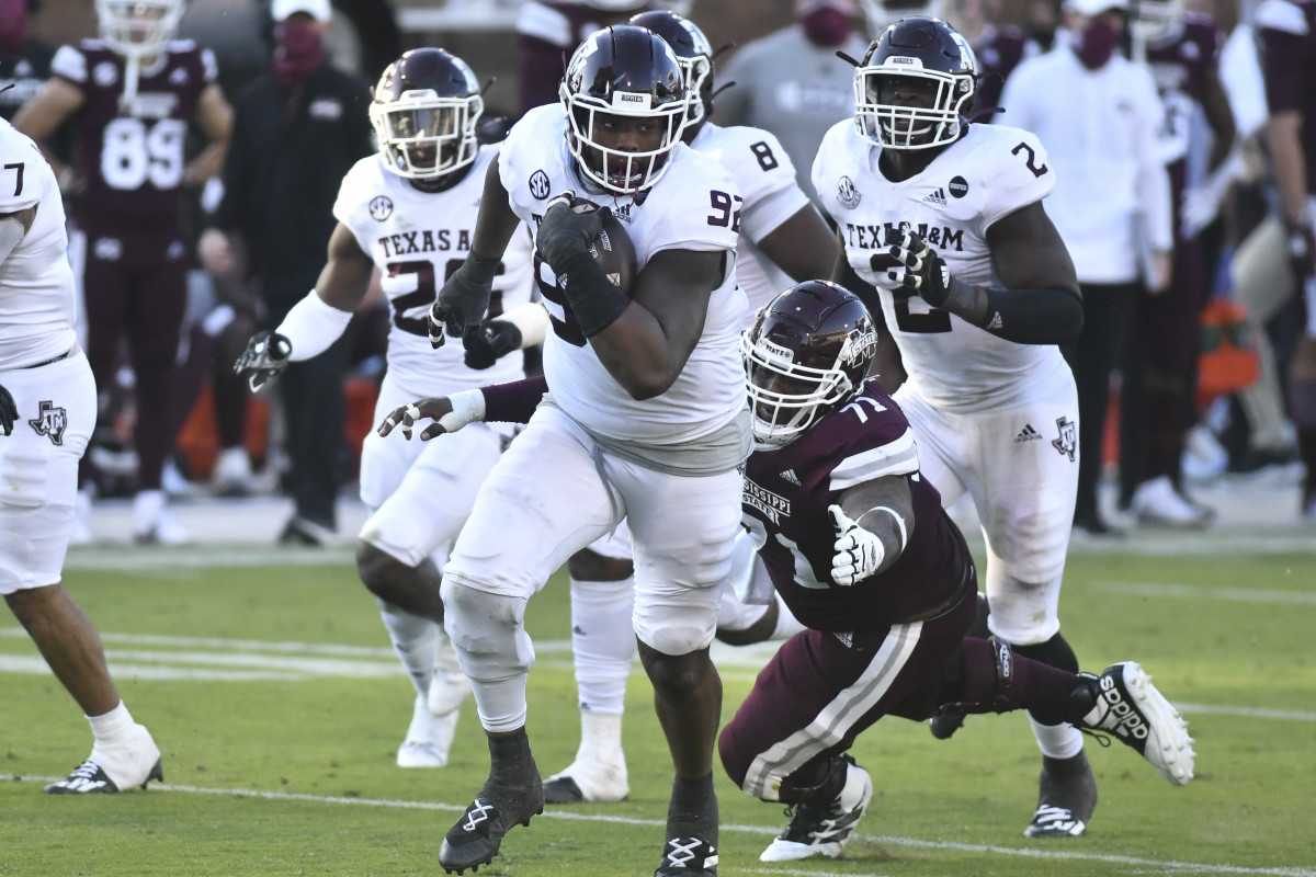 Oct 17, 2020; Starkville, Mississippi, USA; Texas A&M Aggies defensive lineman Jayden Peevy (92) runs the ball after recovering a fumble agains the Mississippi State Bulldogs during the third quarter at Davis Wade Stadium at Scott Field. Mandatory Credit: Matt Bush-USA TODAY Sports