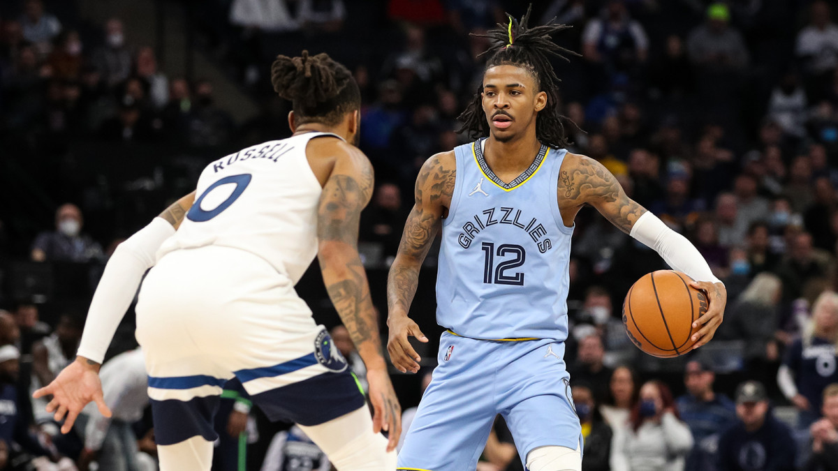Memphis Grizzlies guard Ja Morant (12) dribbles the ball while Minnesota Timberwolves guard D'Angelo Russell.