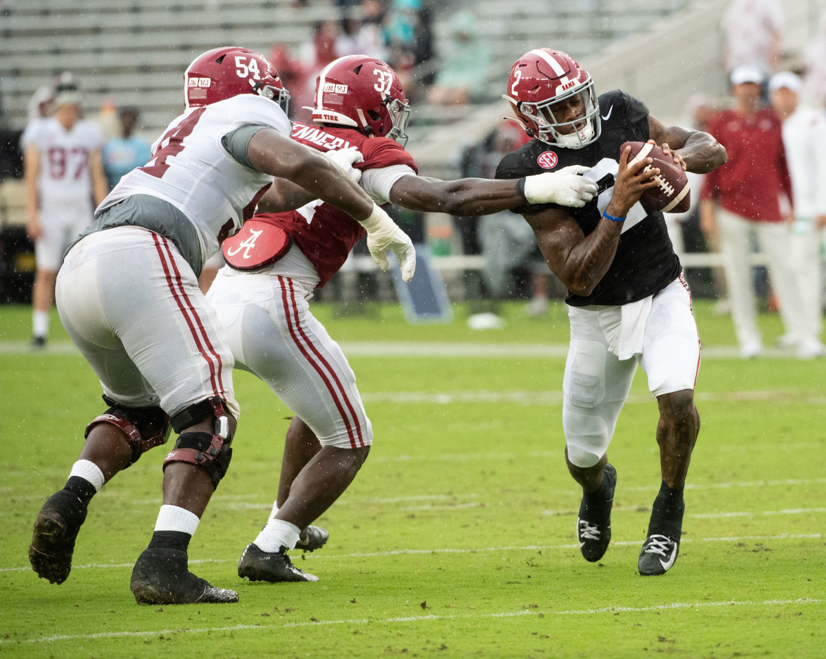 Crimson linebacker Demouy Kennedy (37) tags down White quarterback Jalen Milroe (2) during the A-Day game at Bryant-Denny Stadium.