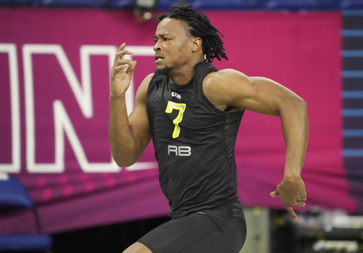 Mar 4, 2022; Indianapolis, IN, USA; North Carolina running back Ty Chandler (RB07) runs the 40-yard dash during the 2022 NFL Scouting Combine at Lucas Oil Stadium.
