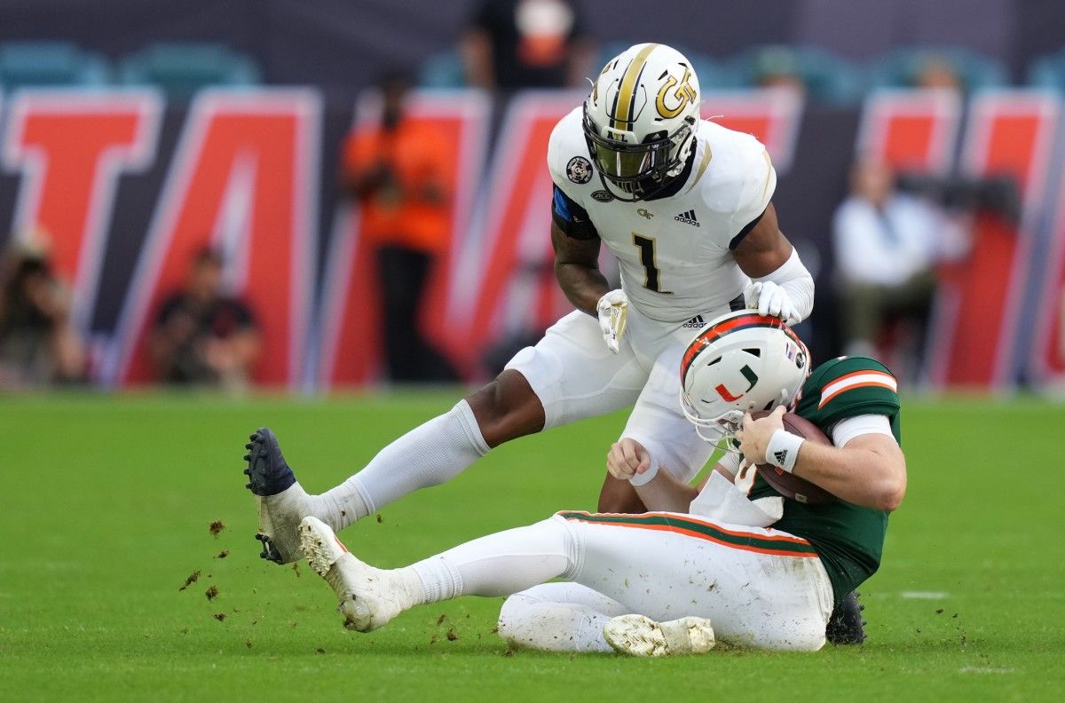 Miami Hurricanes quarterback Tyler Van Dyke (9) slides in front of Georgia Tech Yellow Jackets defensive back Juanyeh Thomas (1) during the second half at Hard Rock Stadium.