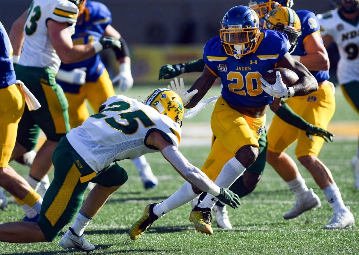 South Dakota State's Pierre Strong, Jr. avoids a tackle by North Dakota State's Michael Tutsie in the annual Dakota Marker game on Saturday, November 6, 2021 at Dana J. Dykhouse Stadium in Brookings. Dakota Marker 2021 004