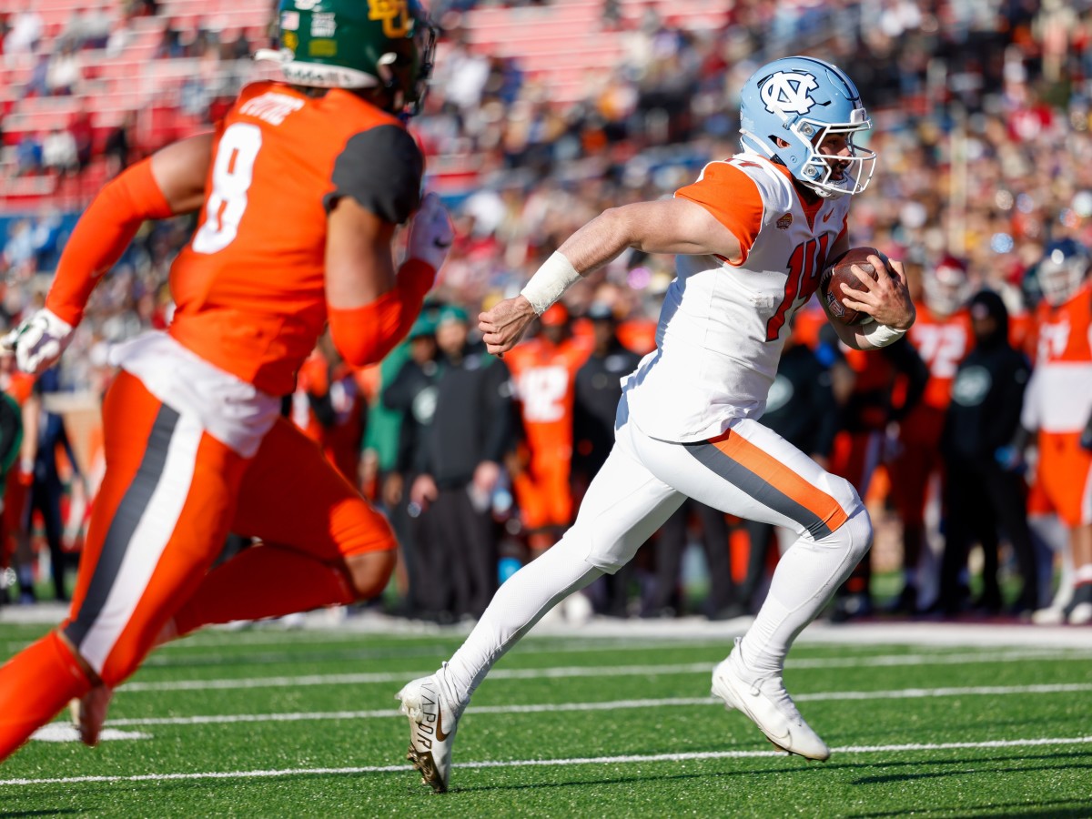 Feb 5, 2022; Mobile, AL, USA; American squad quarterback Sam Howell of North Carolina (14) scores a touchdown in the second half against the National squad at Hancock Whitney Stadium.