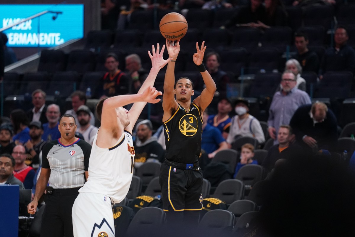 Apr 16, 2022; San Francisco, California, USA; Golden State Warriors guard Jordan Poole (3) shoots the ball against Denver Nuggets center Nikola Jokic (15) in the third quarter during game one of the first round for the 2022 NBA playoffs at the Chase Center. Mandatory Credit: Cary Edmondson-USA TODAY Sports