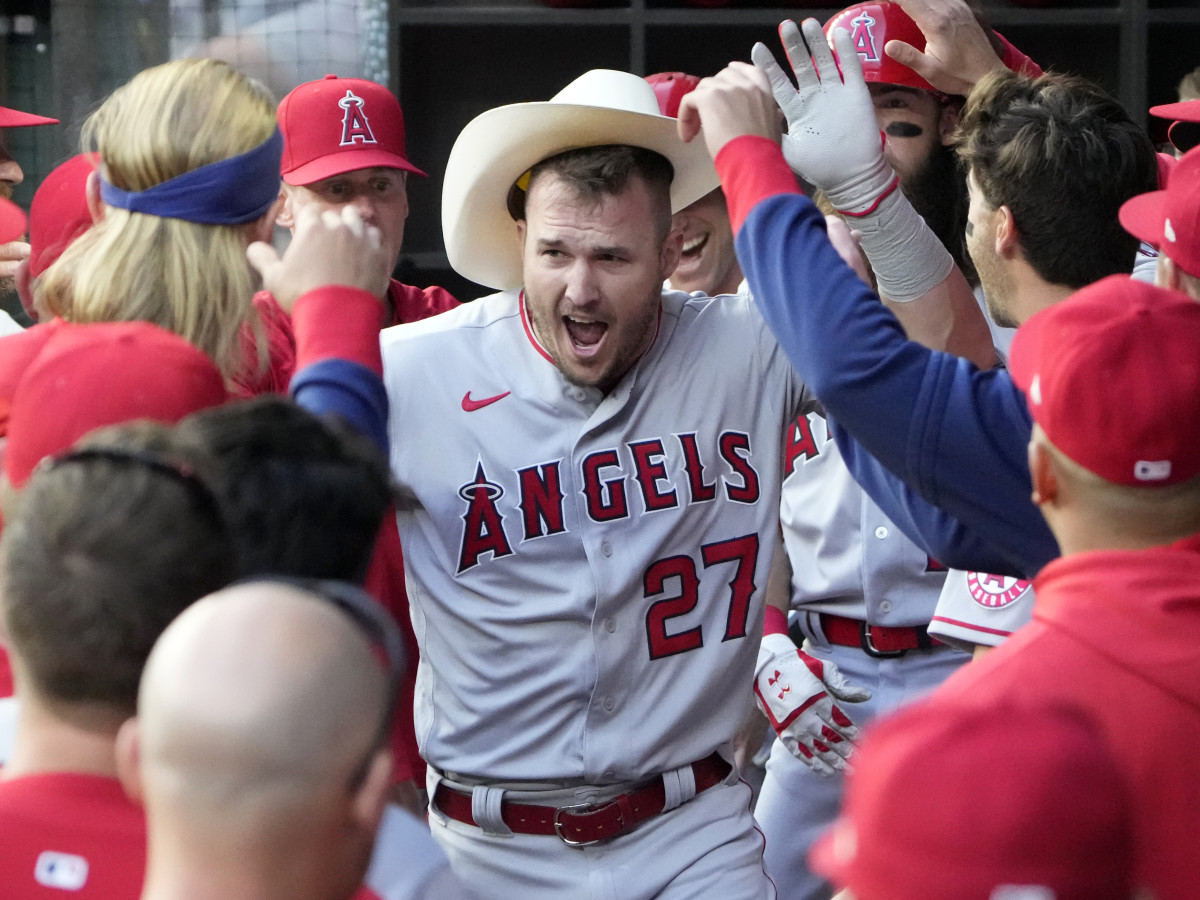 Apr 14, 2022; Arlington, Texas, USA; Los Angeles Angels center fielder Mike Trout (27) celebrates his home run with teammates in the dugout against the Texas Rangers during the first inning of a baseball game at Globe Life Field.