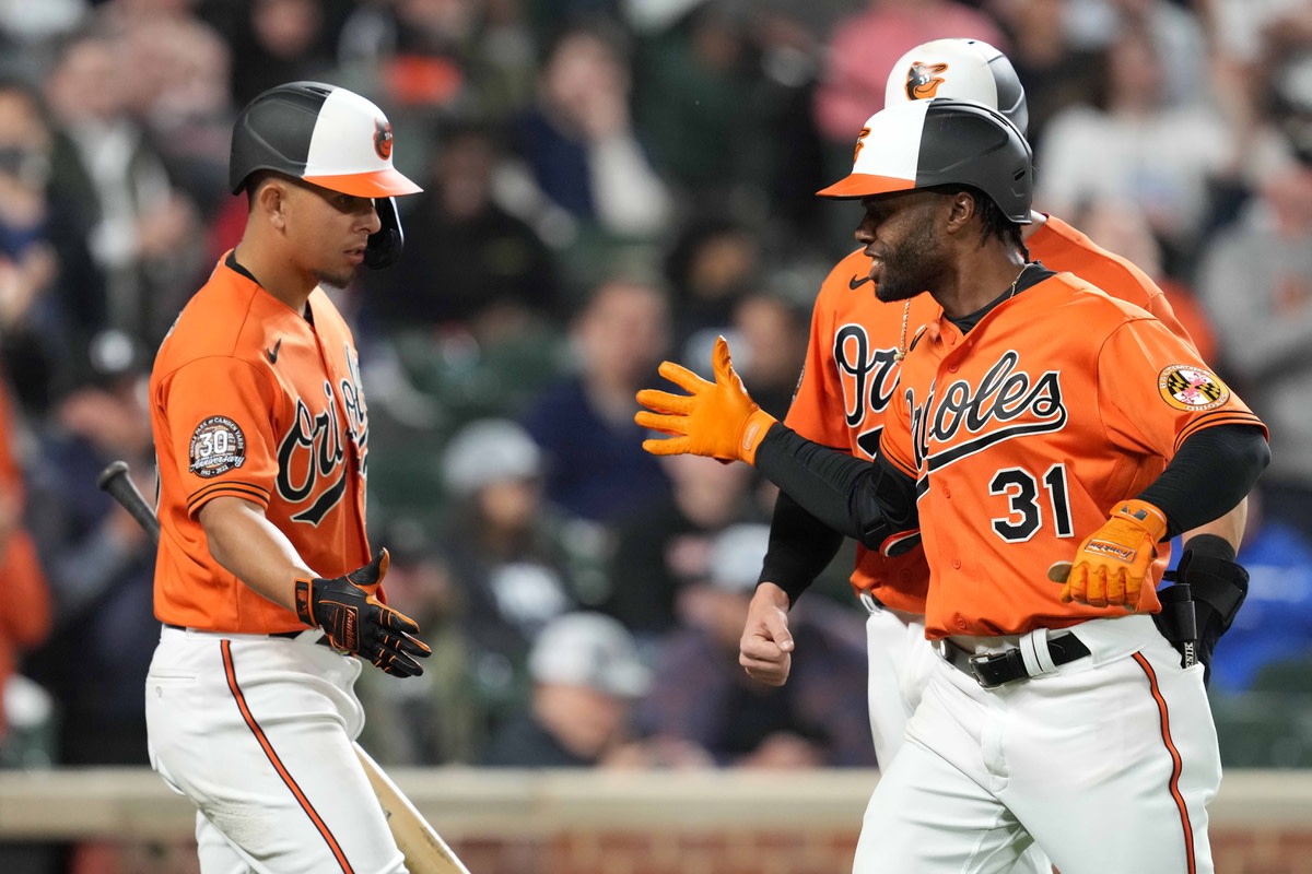 Apr 16, 2022; Baltimore, Maryland, USA; Baltimore Orioles outfielder Cedric Mullins (31) greeted by third baseman Ramon Urias (29) in the third inning after his two run home run against the New York Yankees at Oriole Park at Camden Yards. Mandatory Credit: Mitch Stringer-USA TODAY Sports